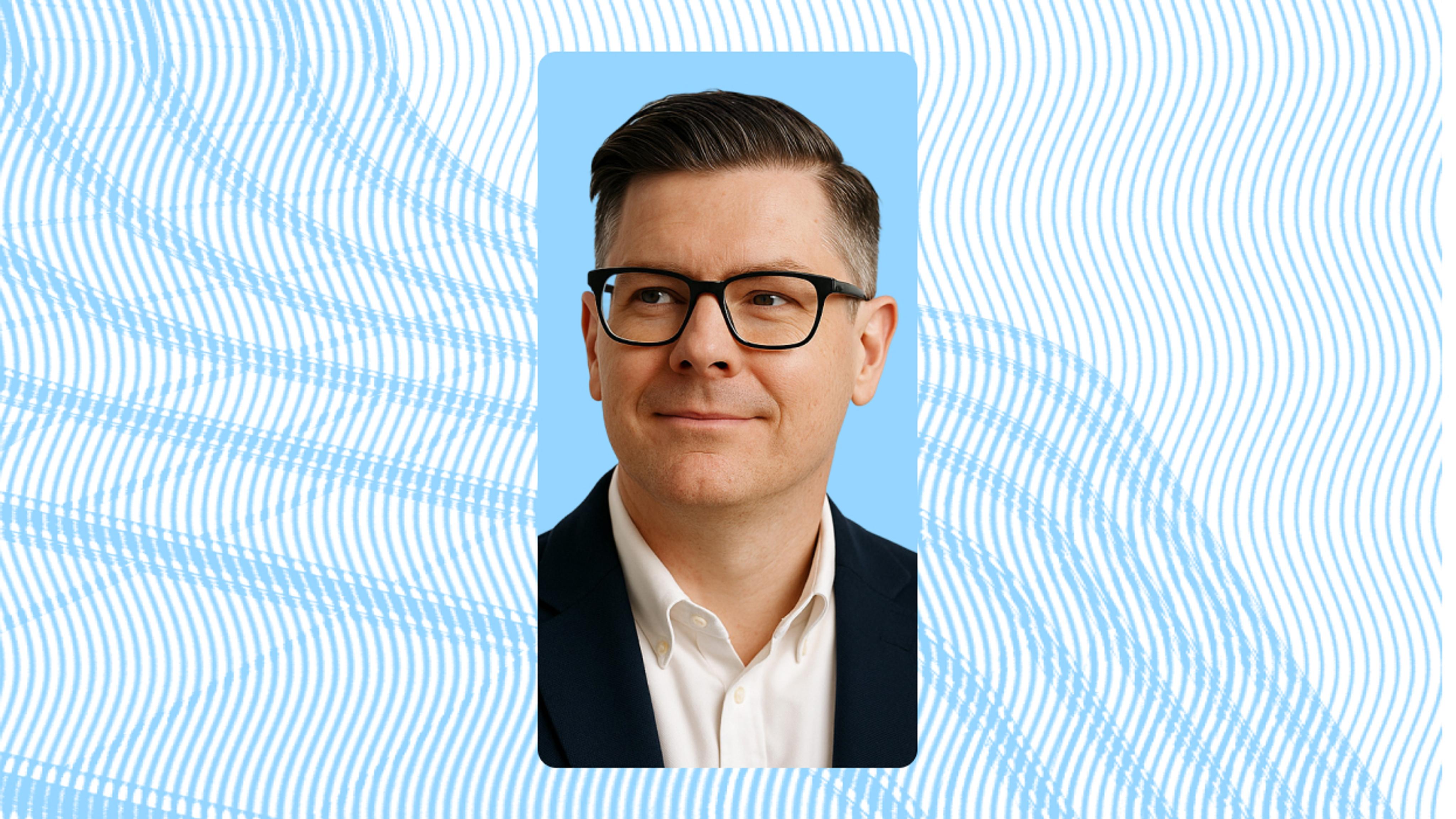 Man wearing glasses with blue background 