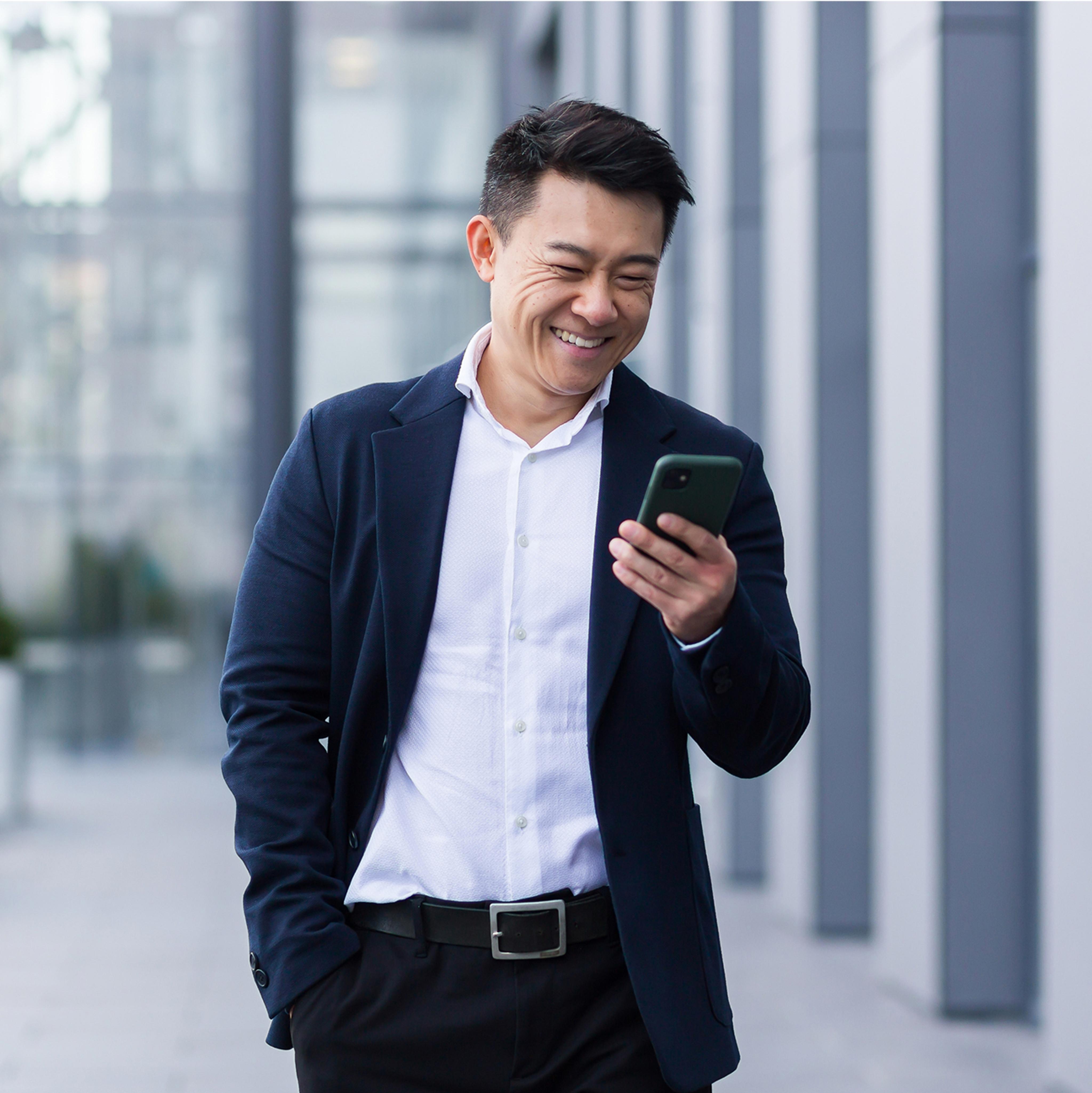 man smiling at phone