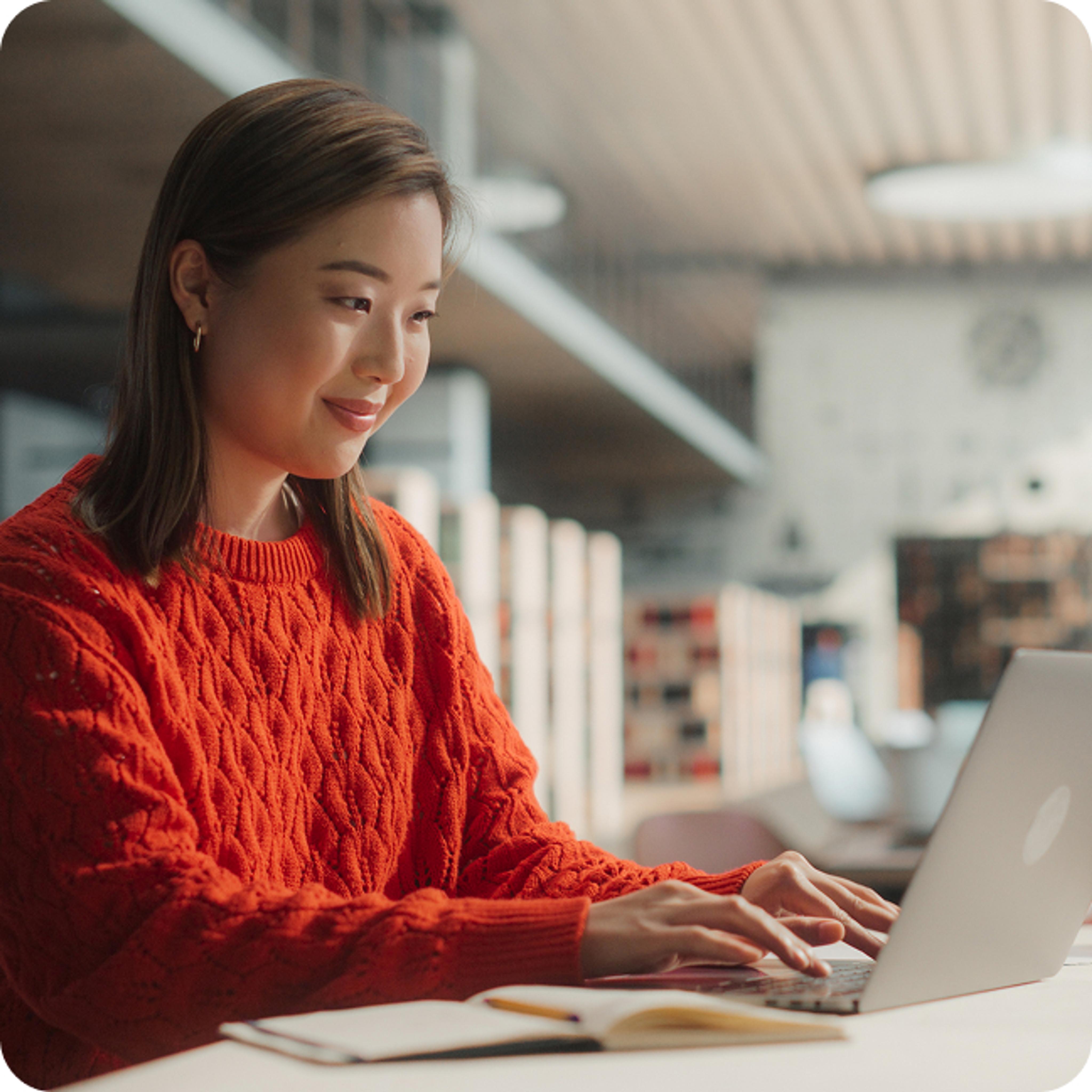 Smiling young woman working on a computer
