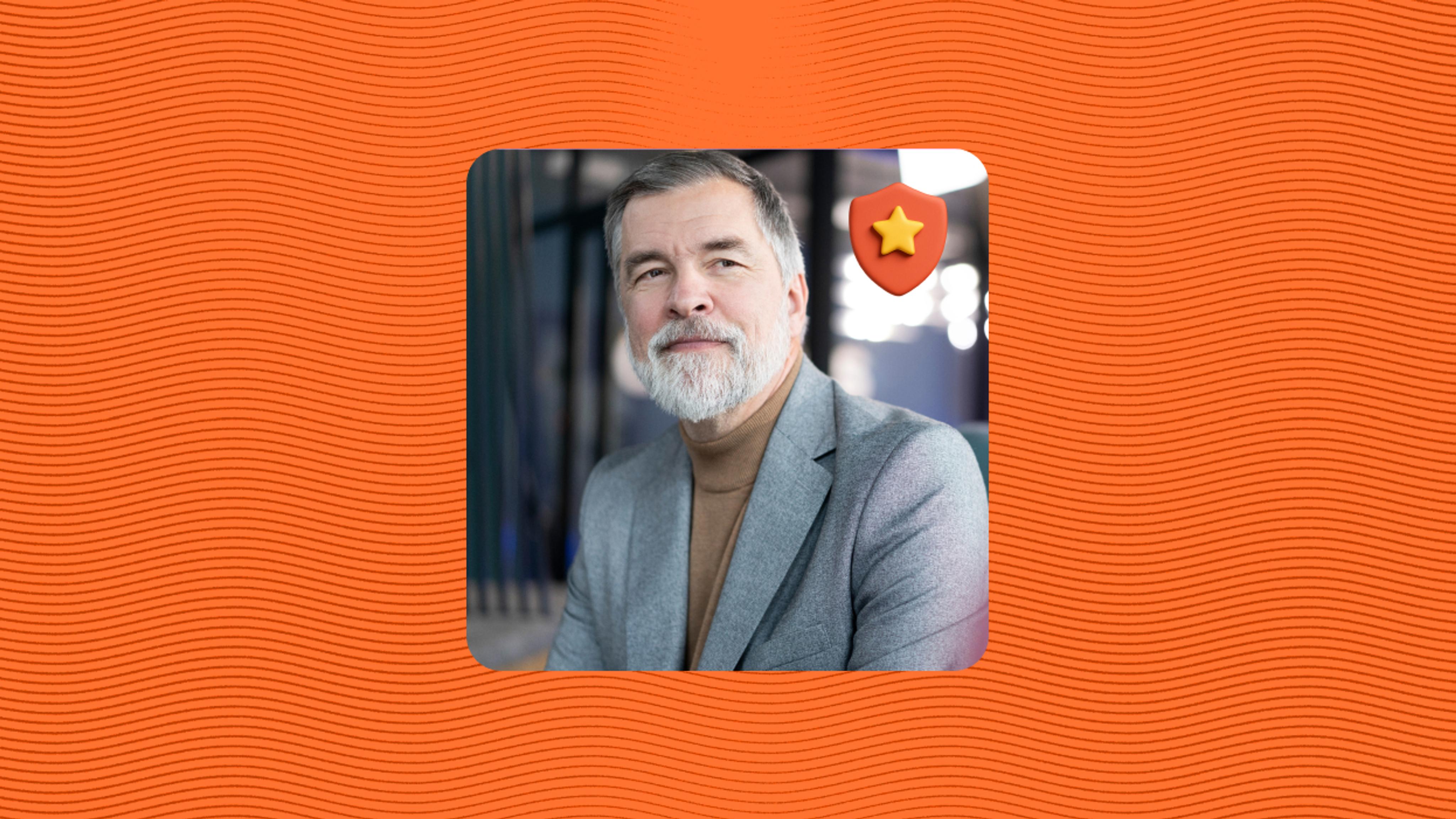 A mature man with gray hair and a beard, wearing a gray blazer and brown turtleneck, is smiling and looking to the side. A star-shaped badge icon appears near him. The background features orange wavy lines.