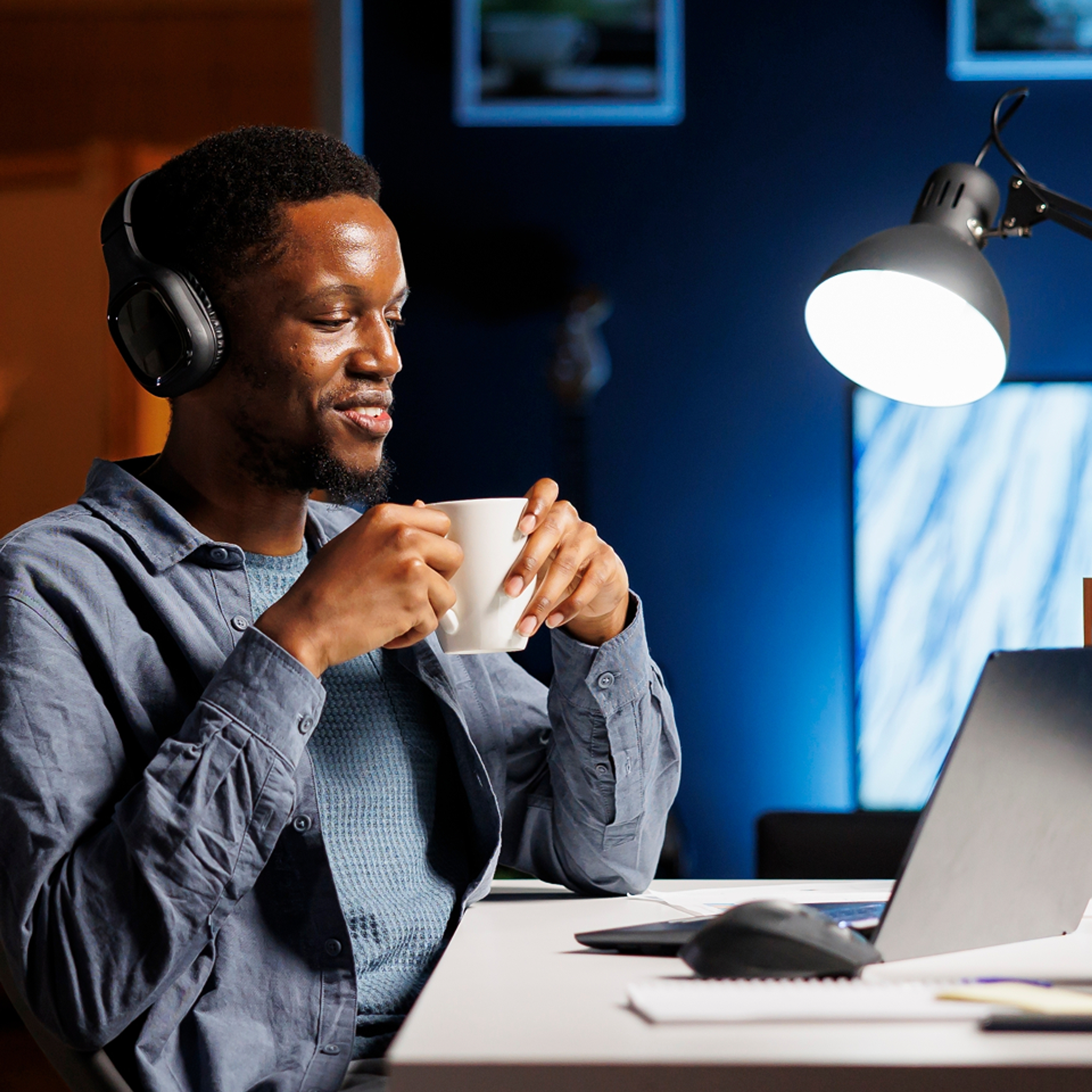 man with mug looking at laptop