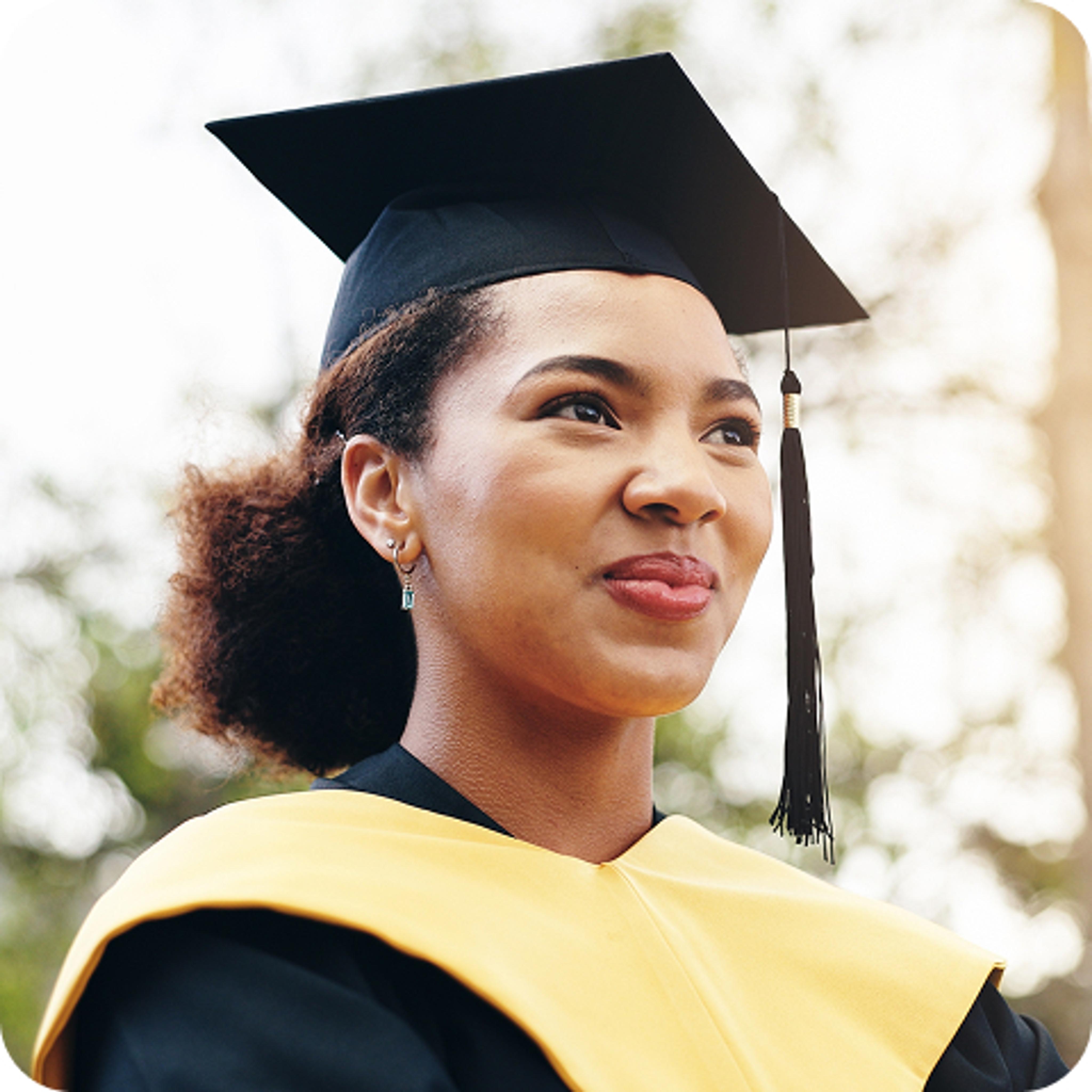 Smiling woman in a graduation gown and cap. 