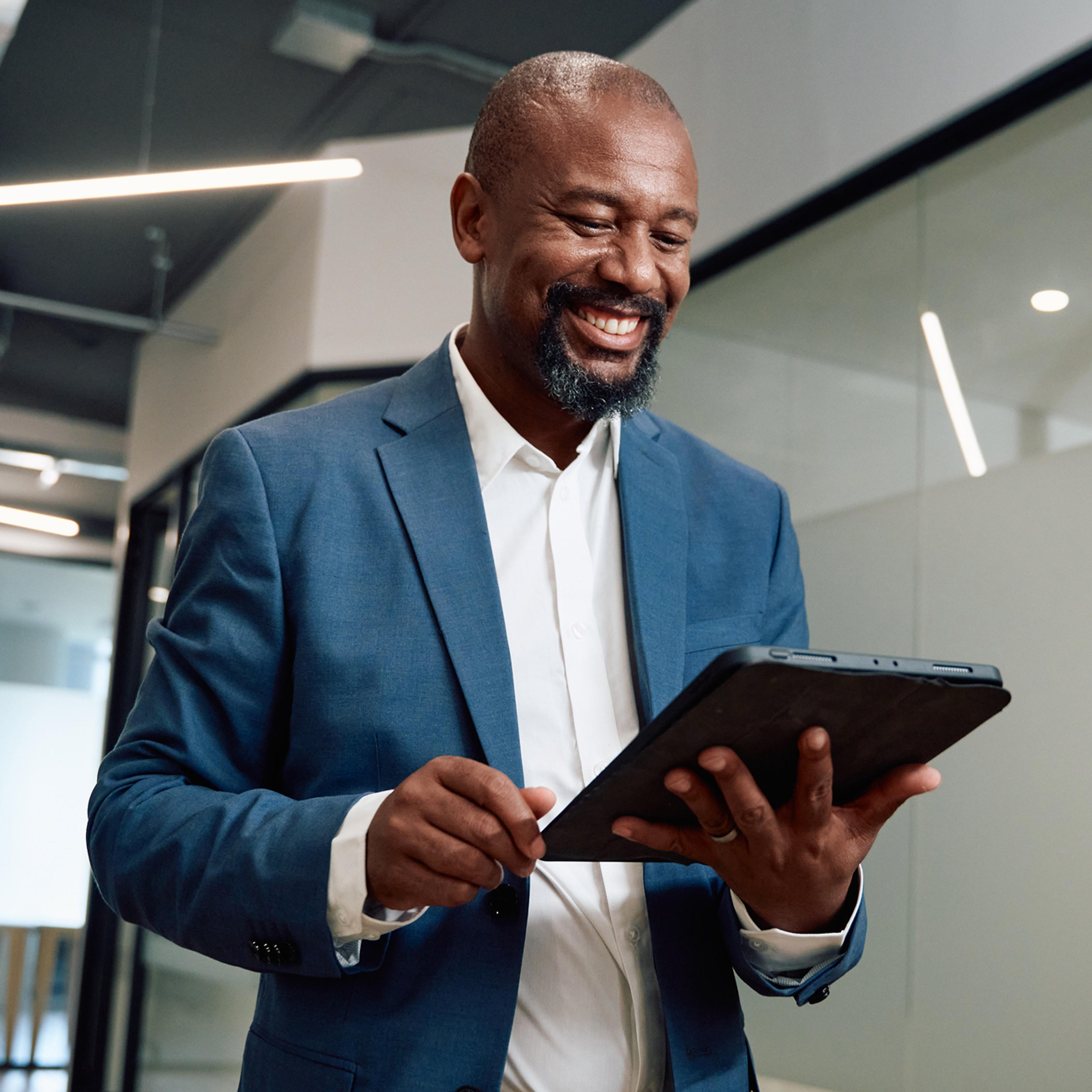 man smiling at tablet
