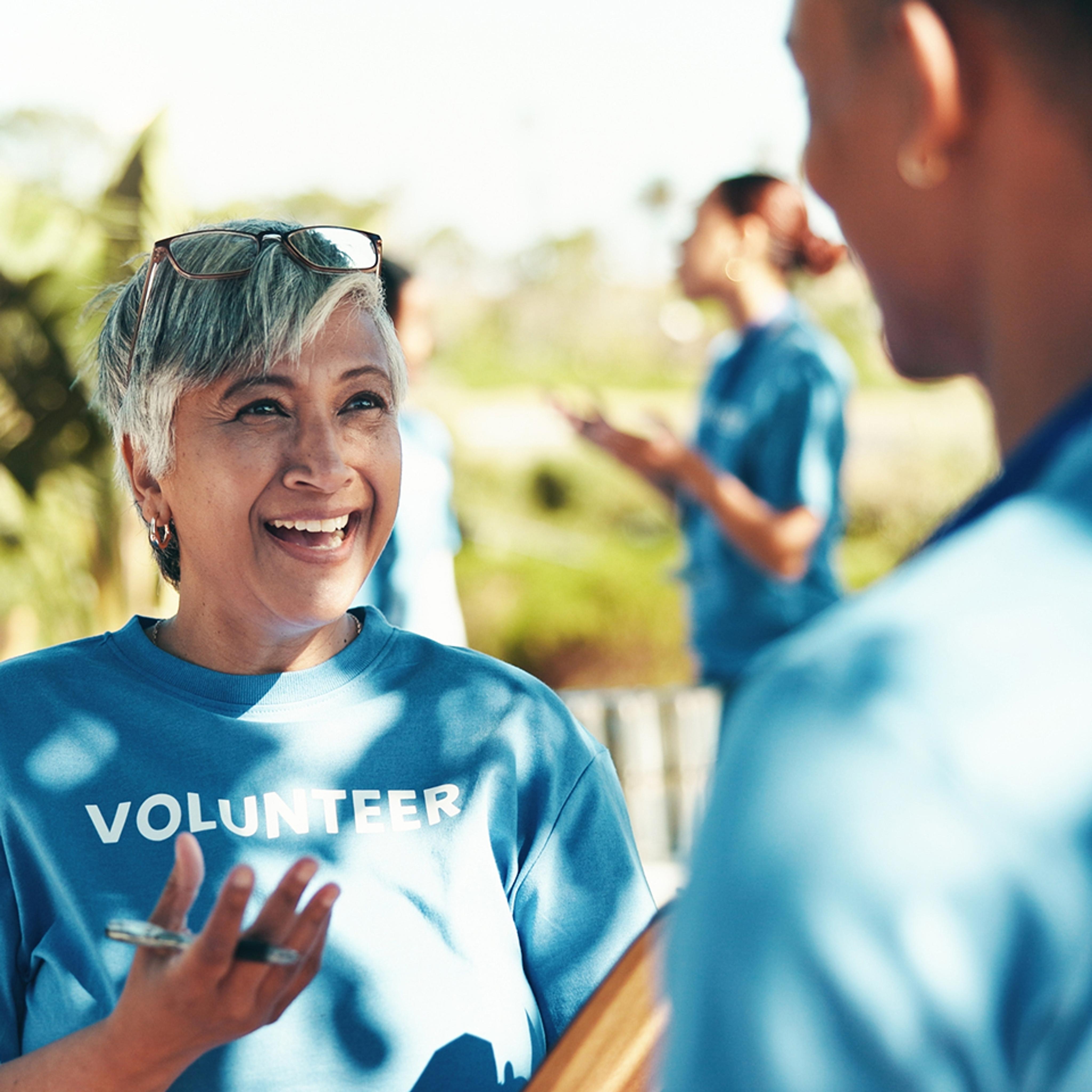 smiling woman wearing "volunteer" shirt