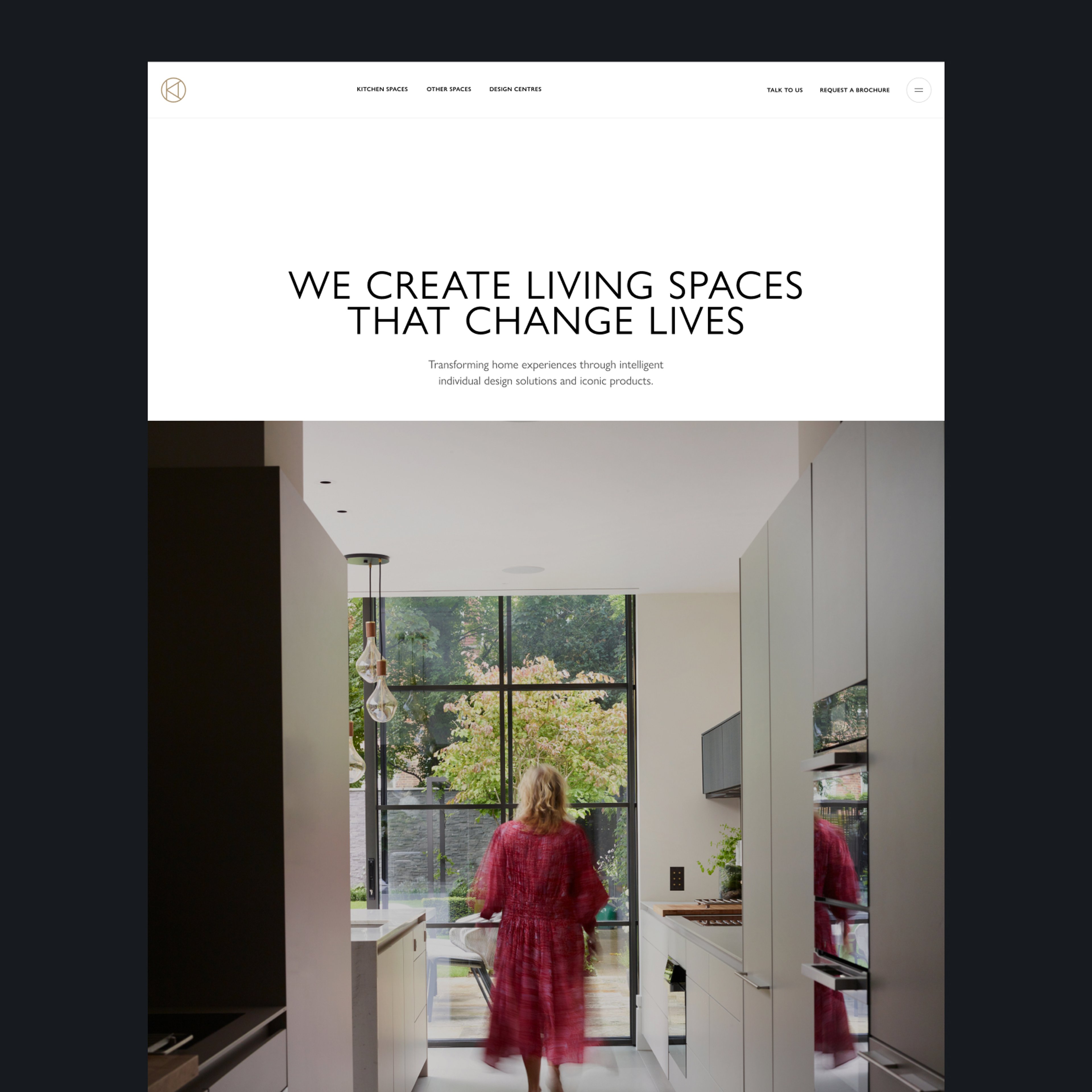 Kitchen Architecture homepage on a black background, featuring the headline "We Create Living Spaces That Change Lives" with the strapline "Transforming home experiences through intelligent individual design solutions and iconic products," above a hero photograph of a woman in a flowing red dress walking through a bright contemporary kitchen with Crittall-style windows, pale cabinetry, and views to a green garden beyond.