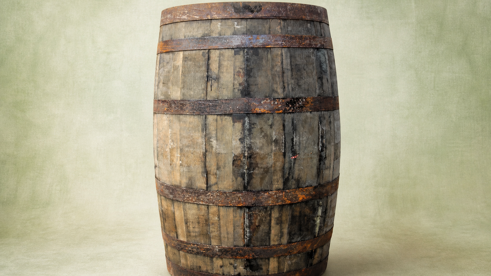 Aged rustic whiskey barrel with weathered wooden staves and rusted metal hoops