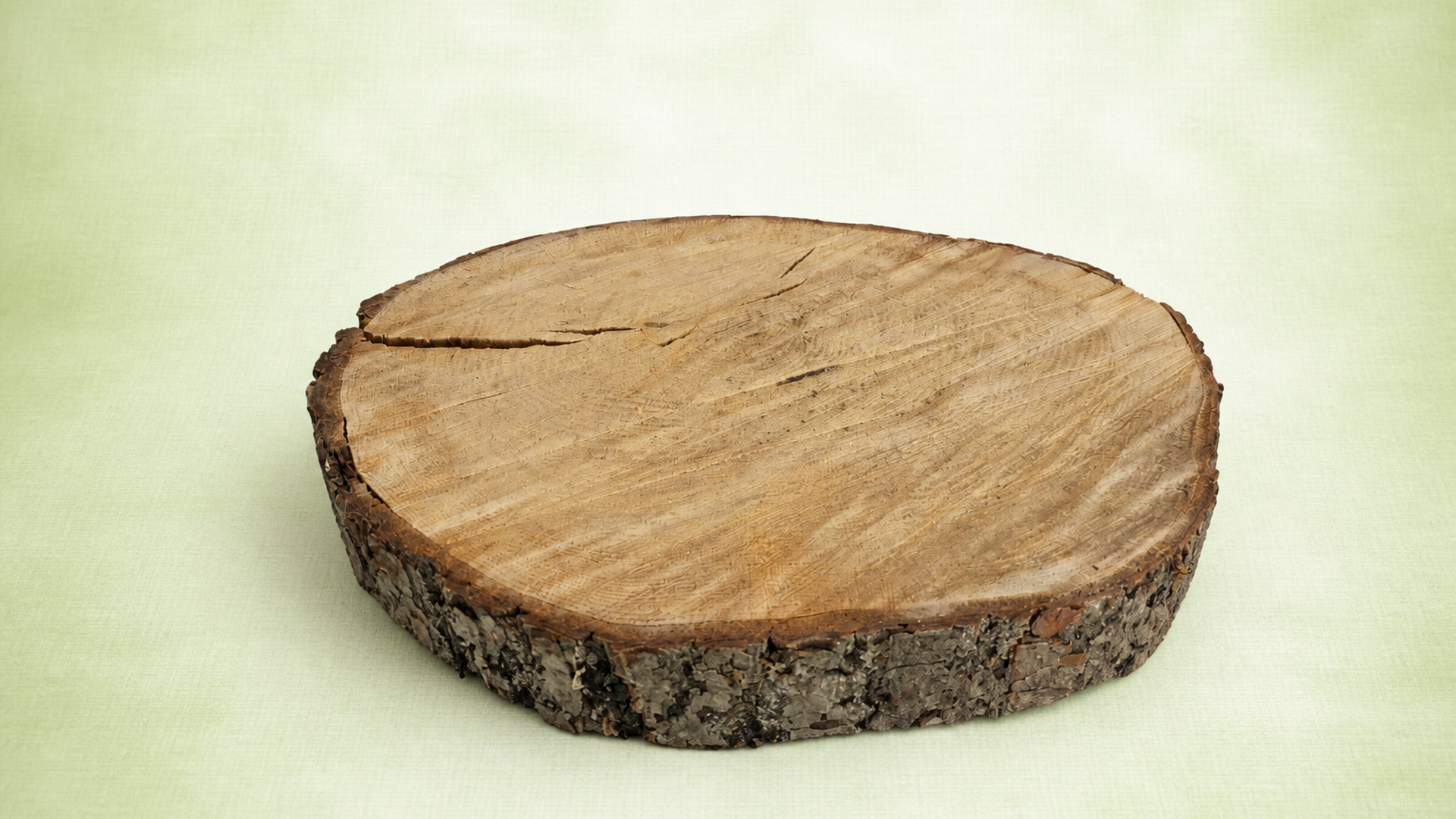 Rustic wooden log slice with natural bark edge and growth rings on the top surface