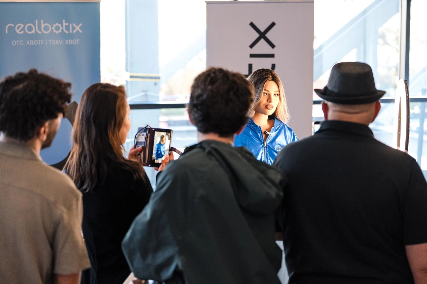 Visitors gathered around an Echo robot at a live event