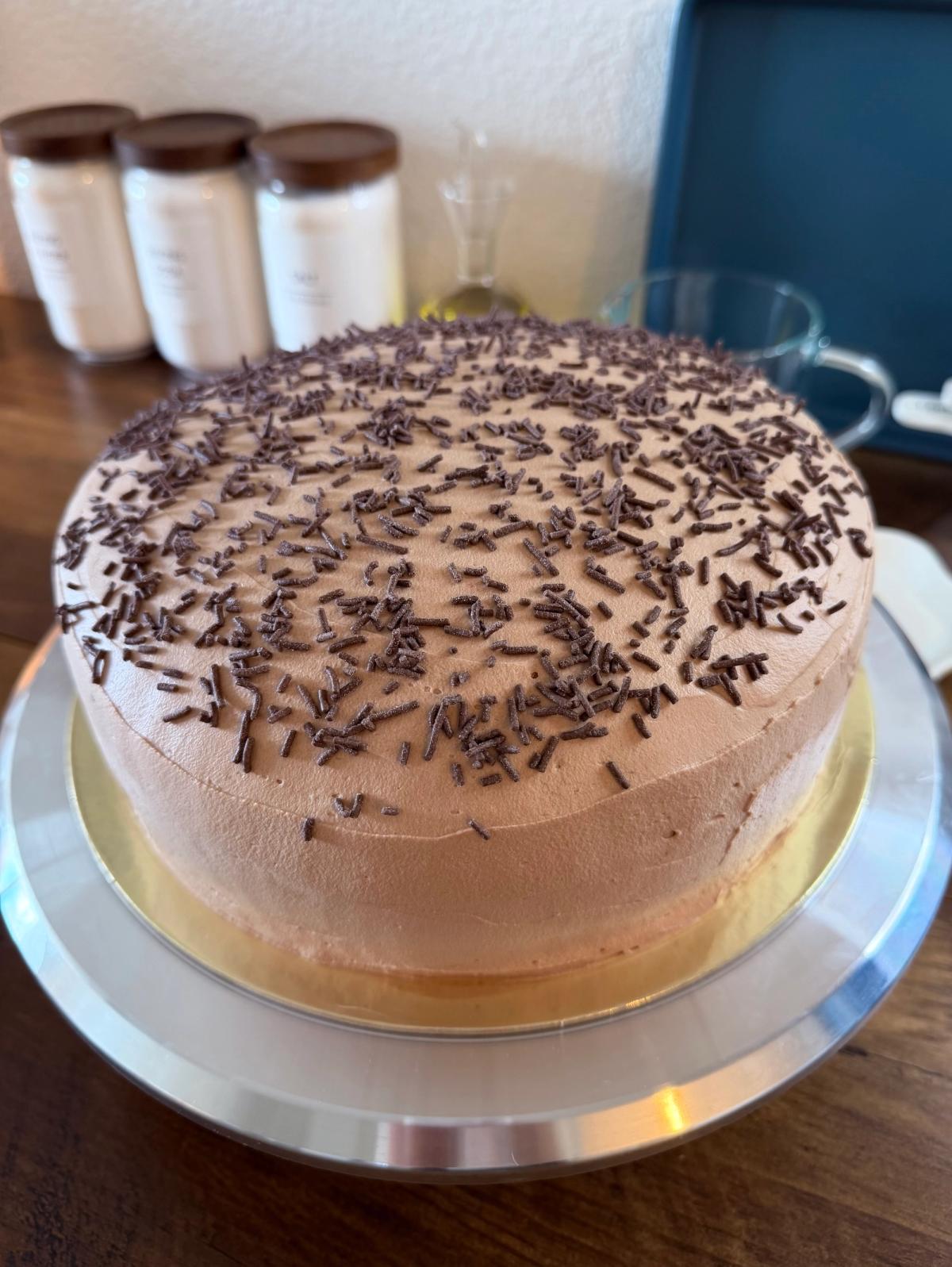 Slice of chocolate layer cake with whipped chocolate frosting