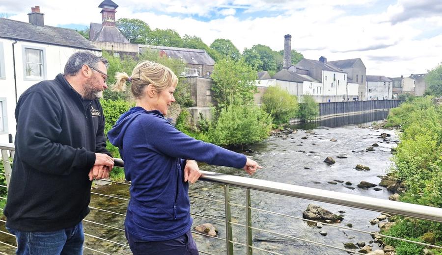 Jennings and West Cumbria Rivers Trust on the footbridge over the River Cocker