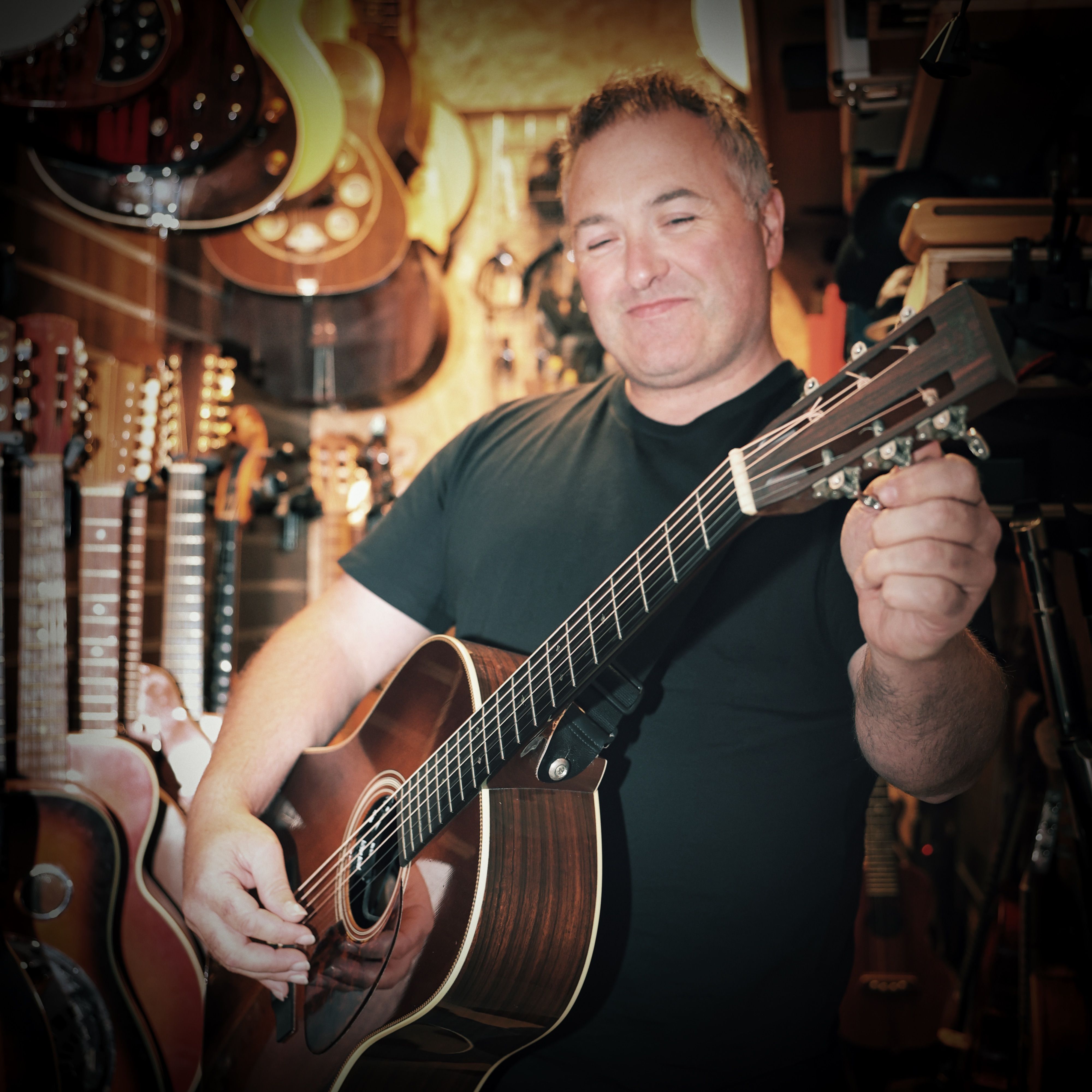 Ger O'Donnel tuning an acoustic guitar