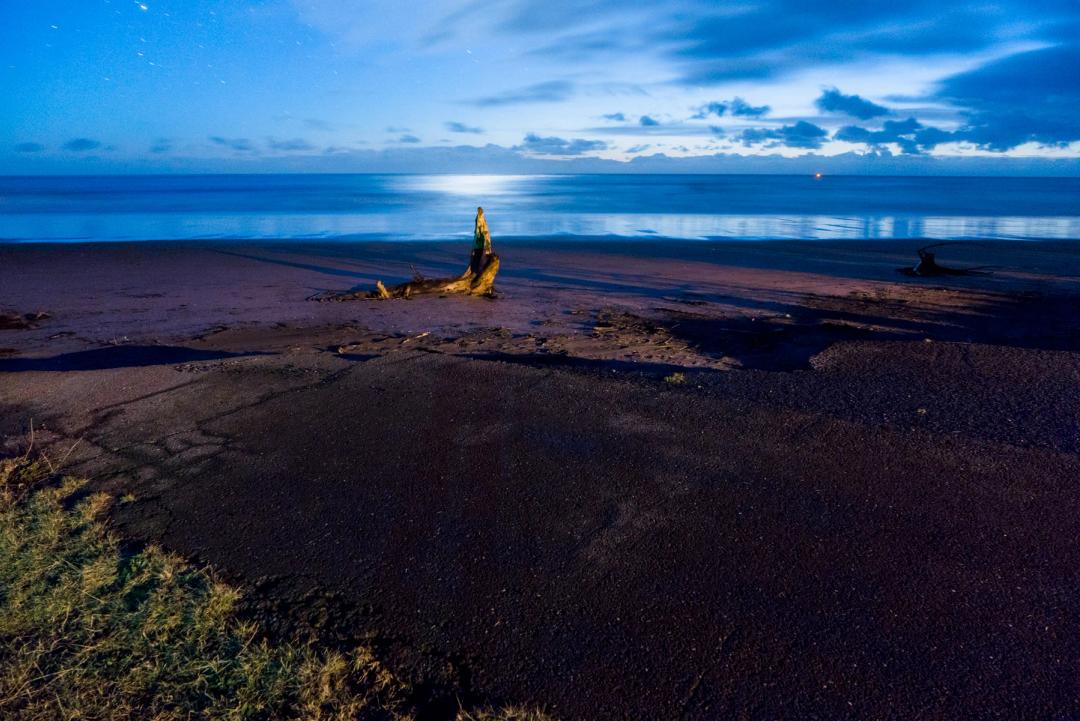 Another road abruptly terminates into the ocean as the low tide exposes an otherwise innocent looking beach at night.