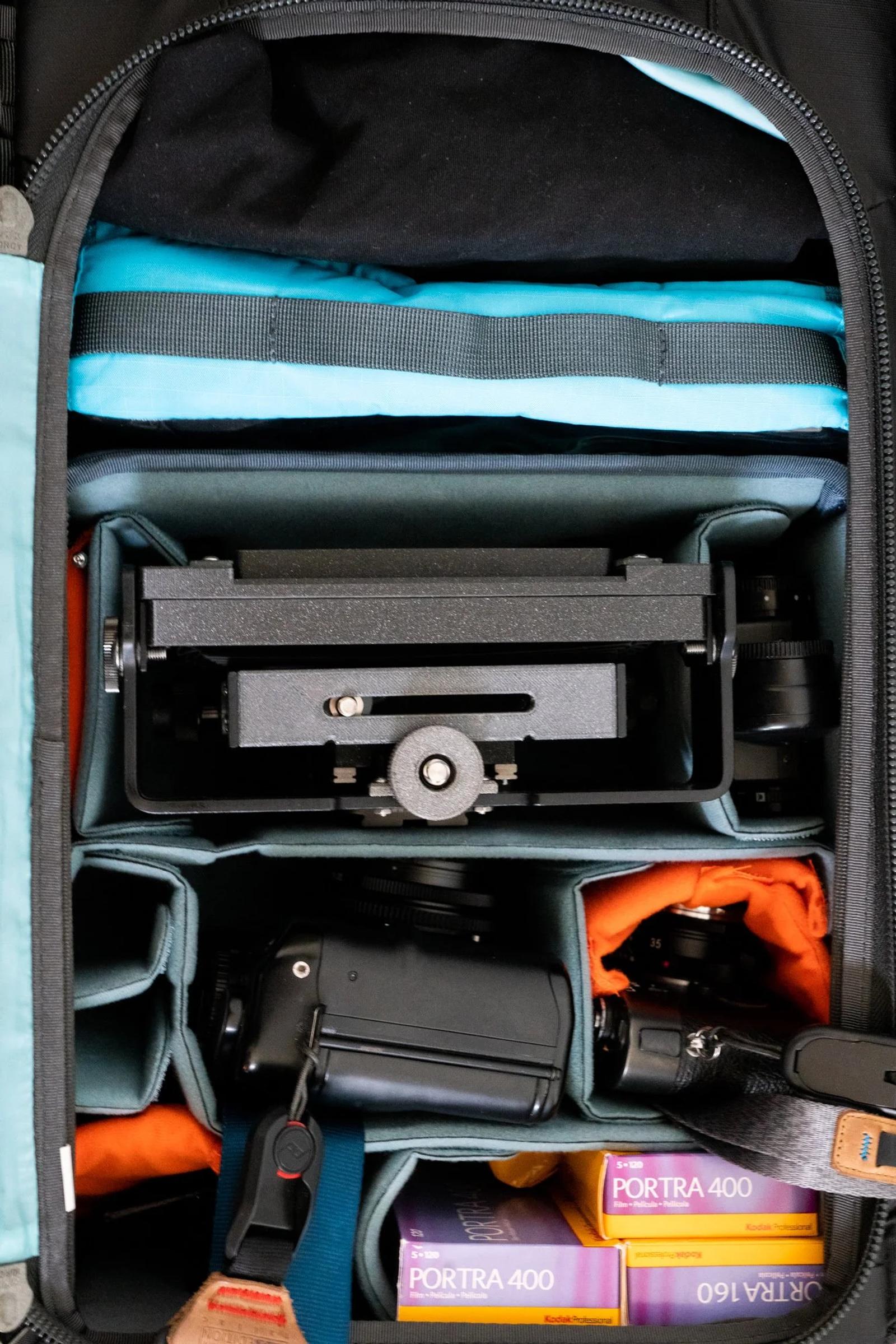 Success. Fitting in the Intrepid large format 4x5 camera, a Mamiya 6 medium format 6x6 rangefinder, and the Leica M6 in a Shimoda Medium DSLR core (V2) unit. The light meter, some film, and a large format lens also fit in, with a bit of room for extras. Above the core unit is an accessory pouch that can hold up to six 4x5 film holders and a dark cloth.