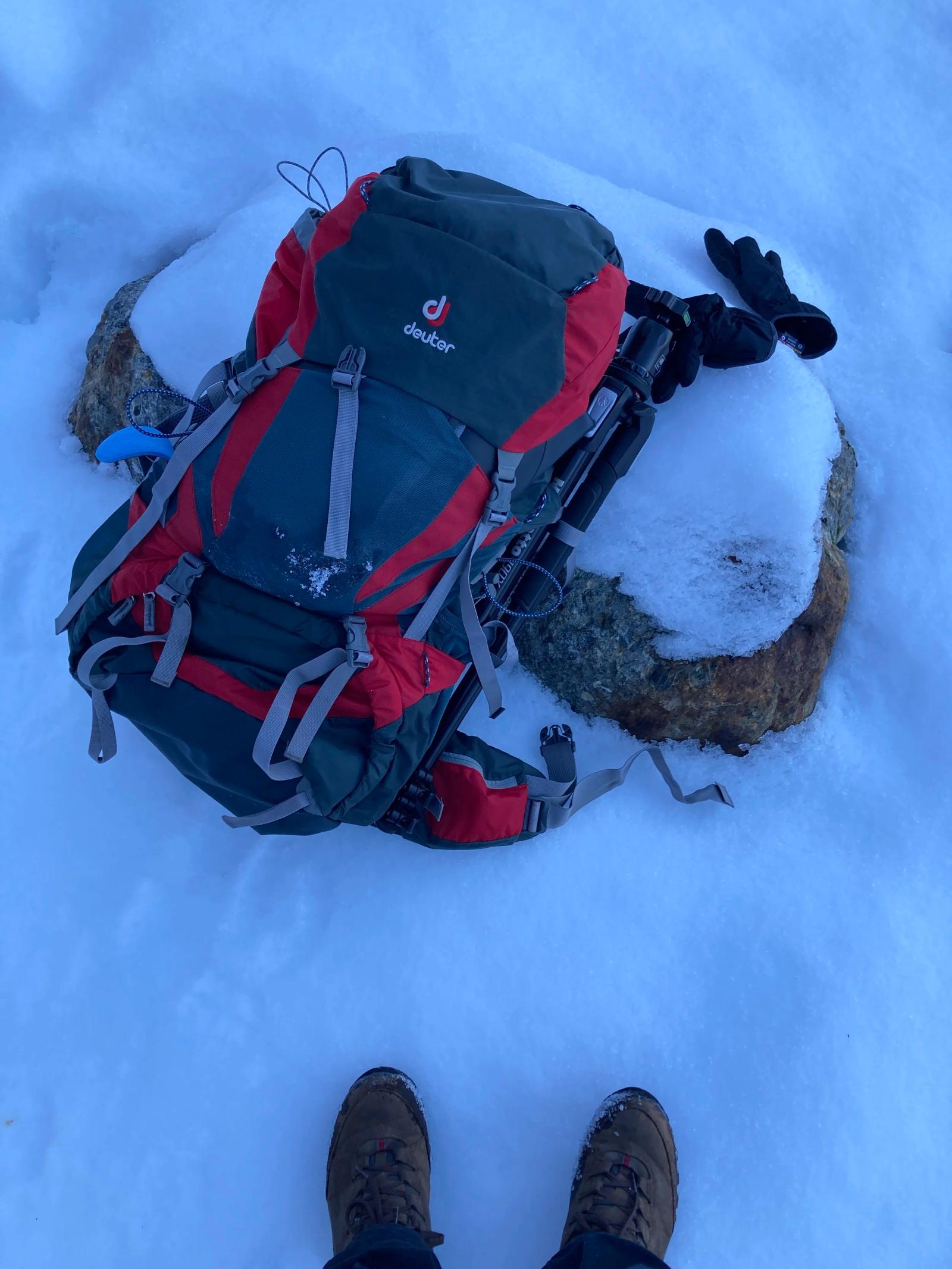 Deuter 70L backpacking bag stuffed with winter gear and a camera insert.