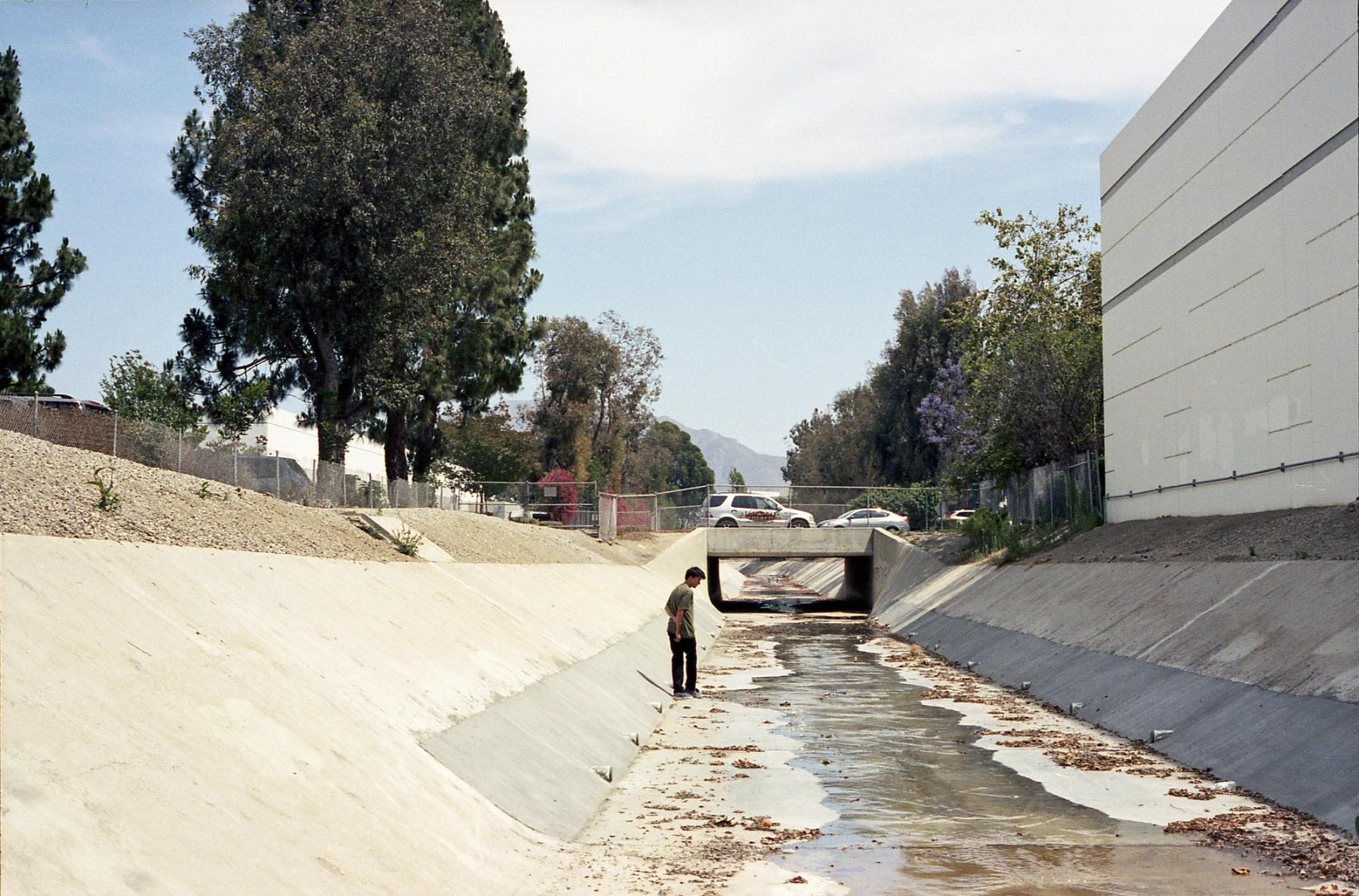 Jared contemplating another often driven by, yet unskated spot in Camarillo. Later, we’d form a temporary dam, sweep the grit, and he’d get the last trick of his part. A high-stakes one push half cab into the bank.