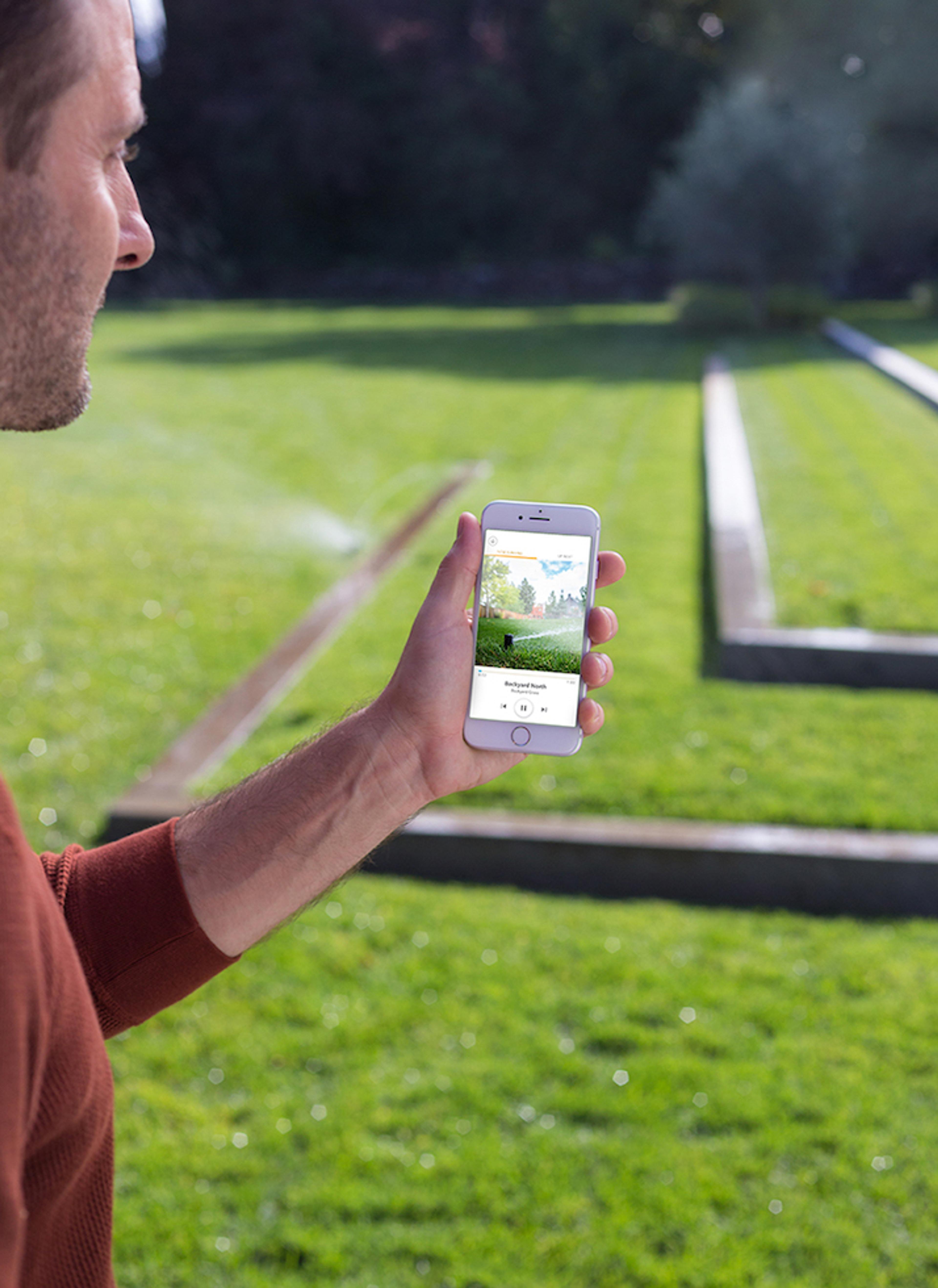 Person using mobile in their lawn