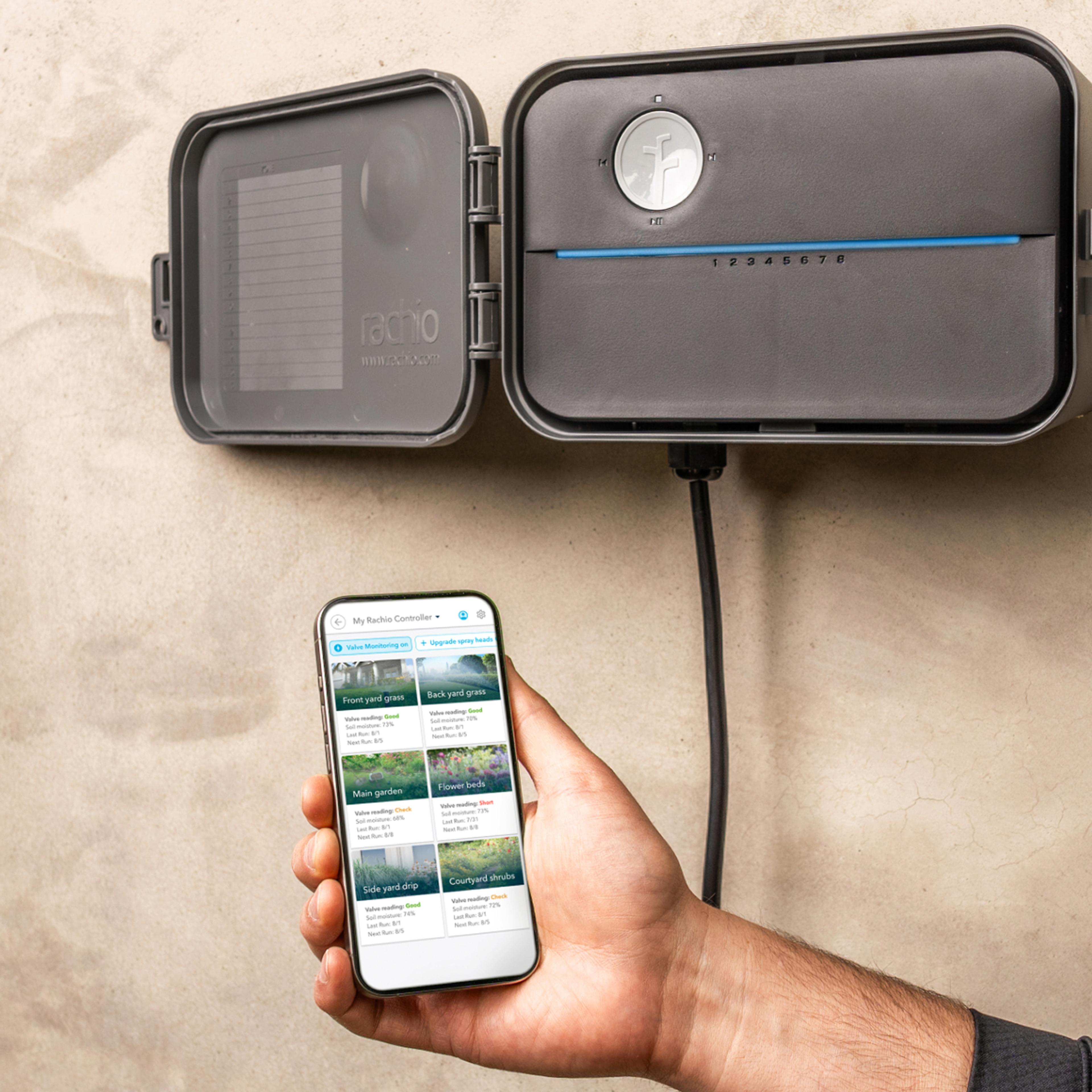 Hand holding phone with the app up in front of an installed outdoor controller