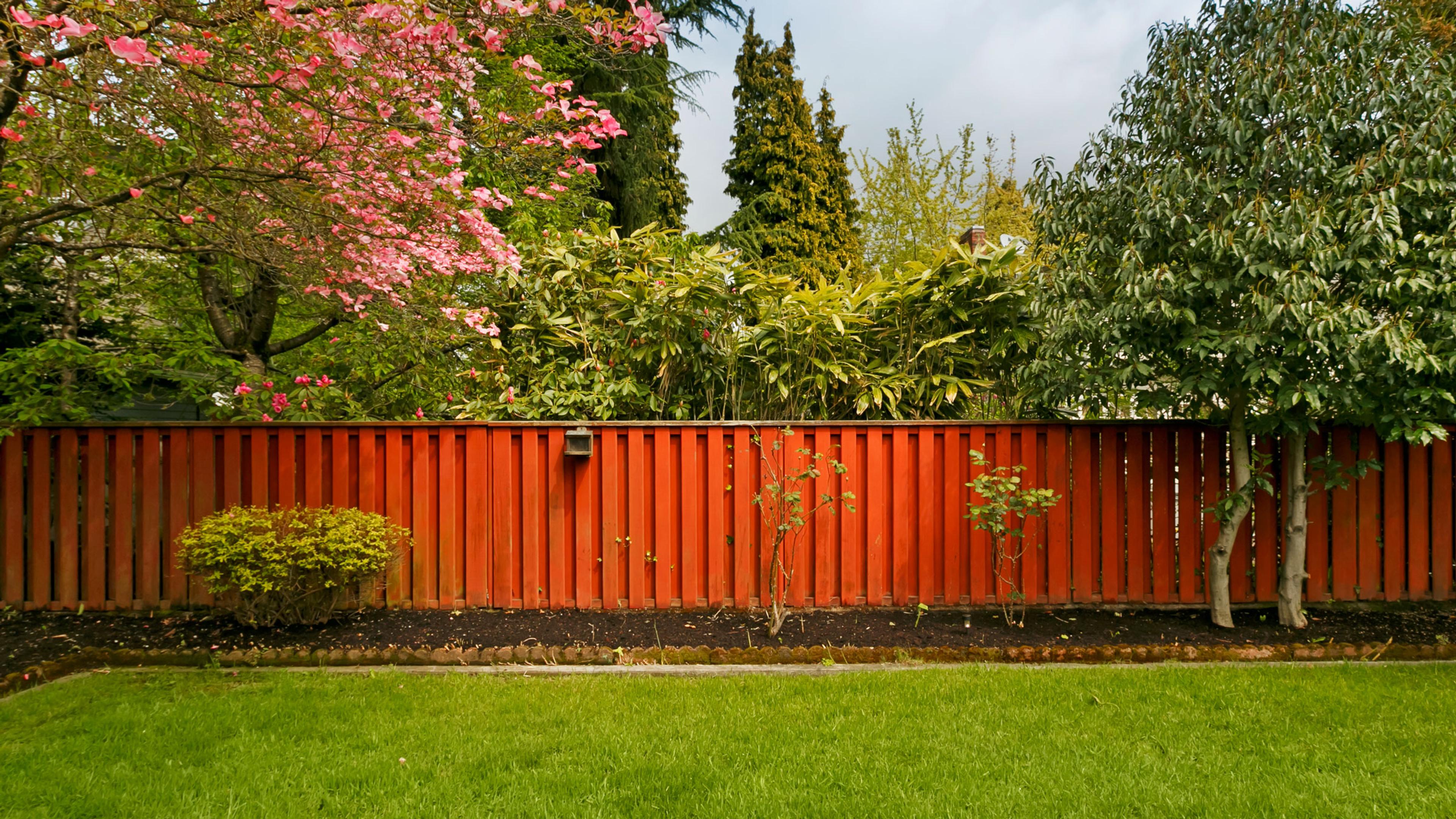Home and yard with people standing in grass