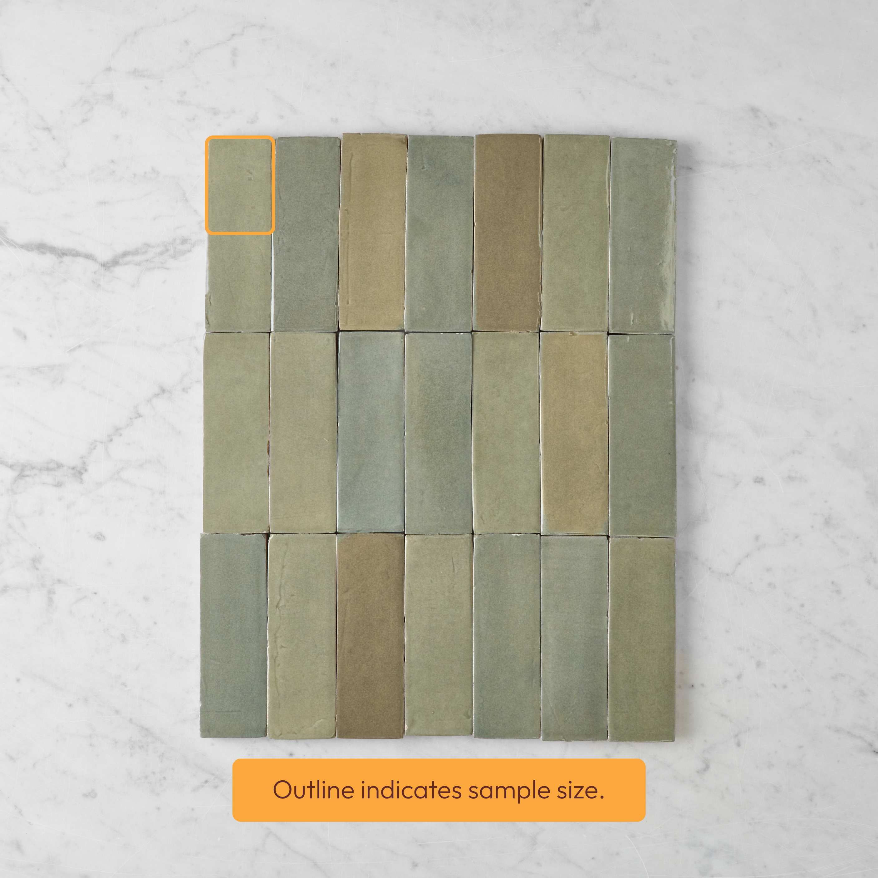 Muted green and beige rectangular tile samples arranged in a grid, with one sample outlined