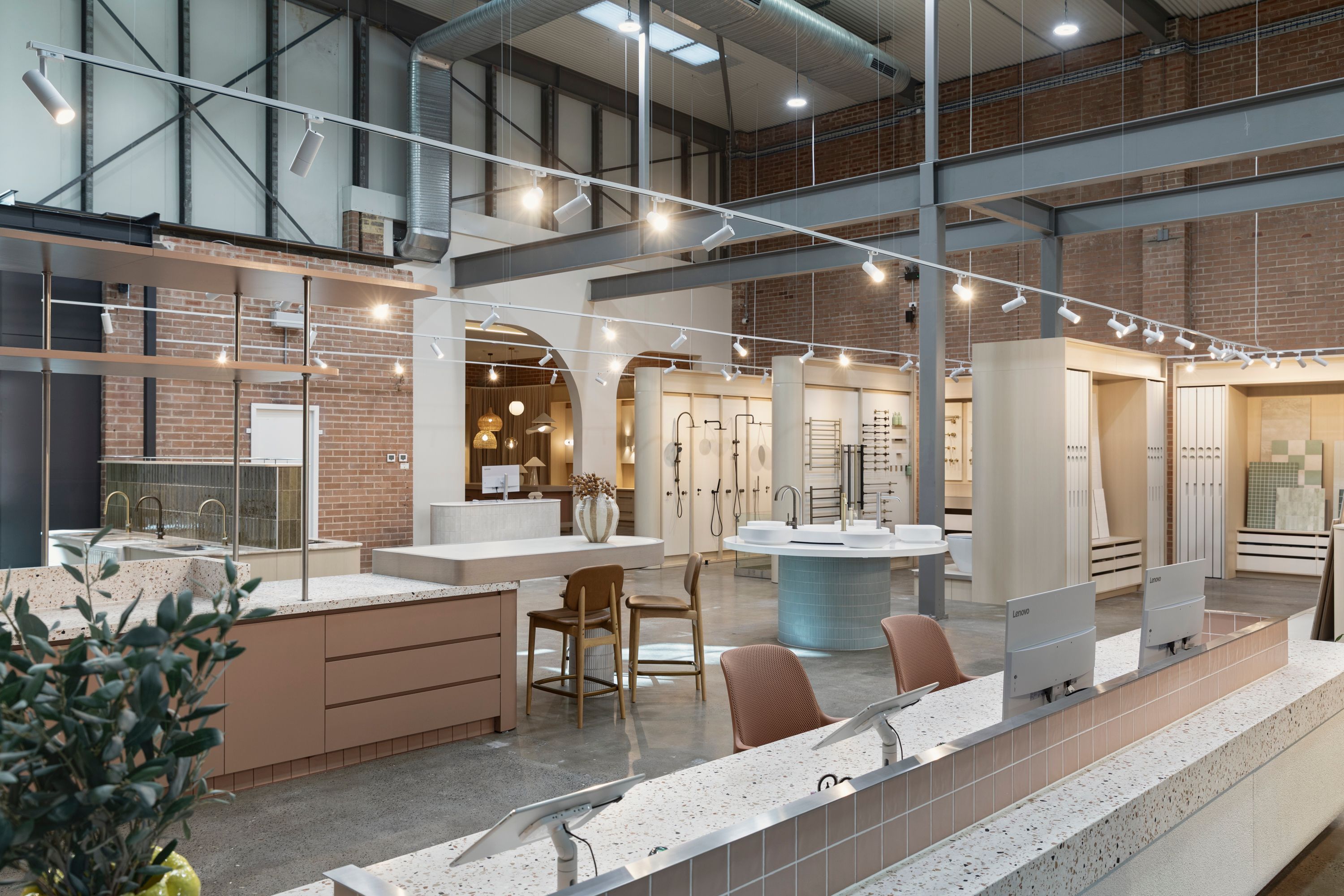 Bathroom showroom with display vanities, basins, tapware and exposed brick walls