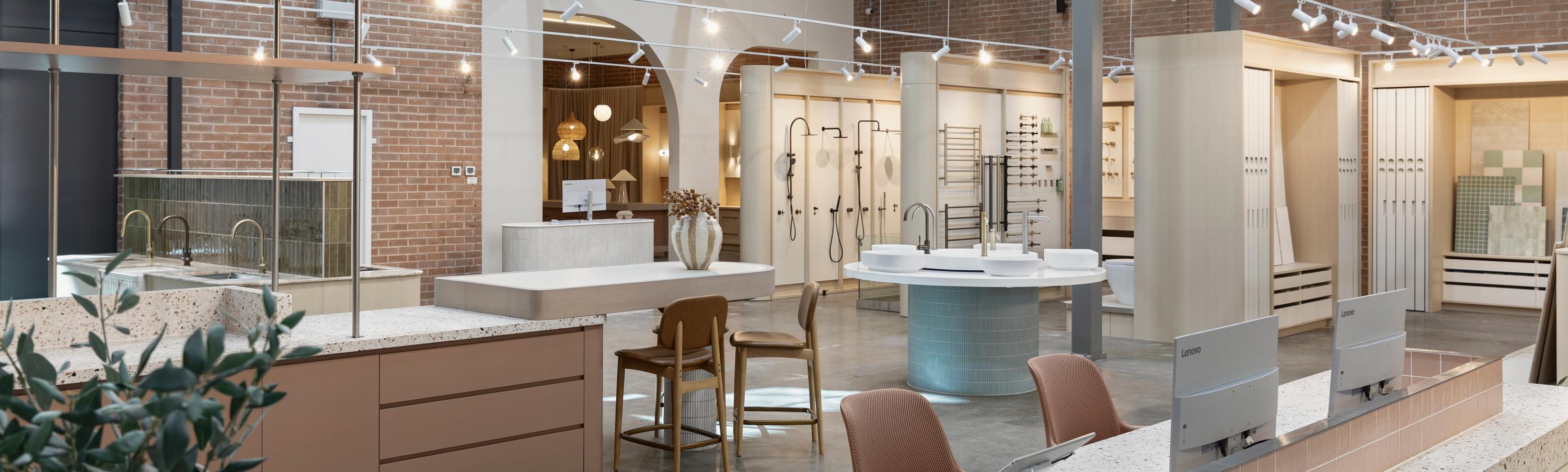 Bathroom showroom with display vanities, basins, tapware and exposed brick walls