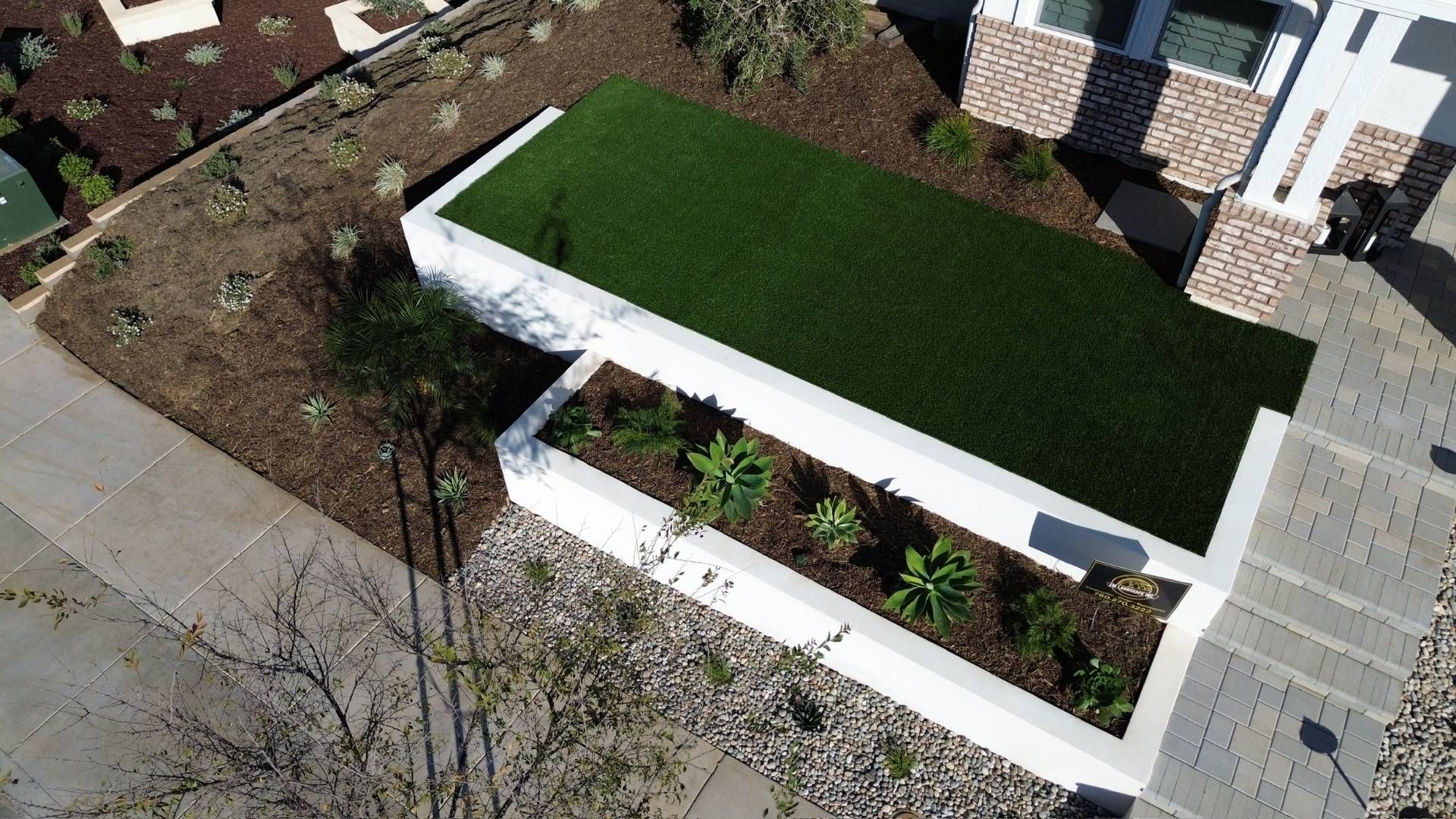 Aerial view of a landscaped yard with retaining walls