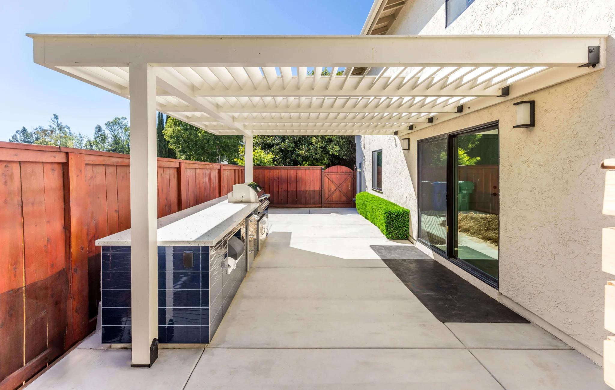 Teknik home addition with outdoor kitchen and pergola