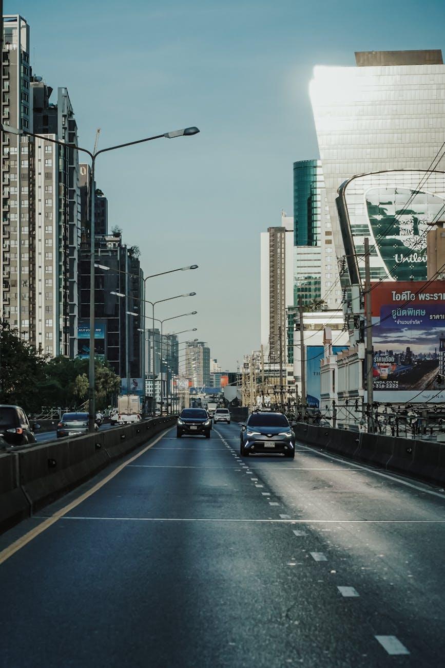 Cars driving along an elevated city highway at midday
