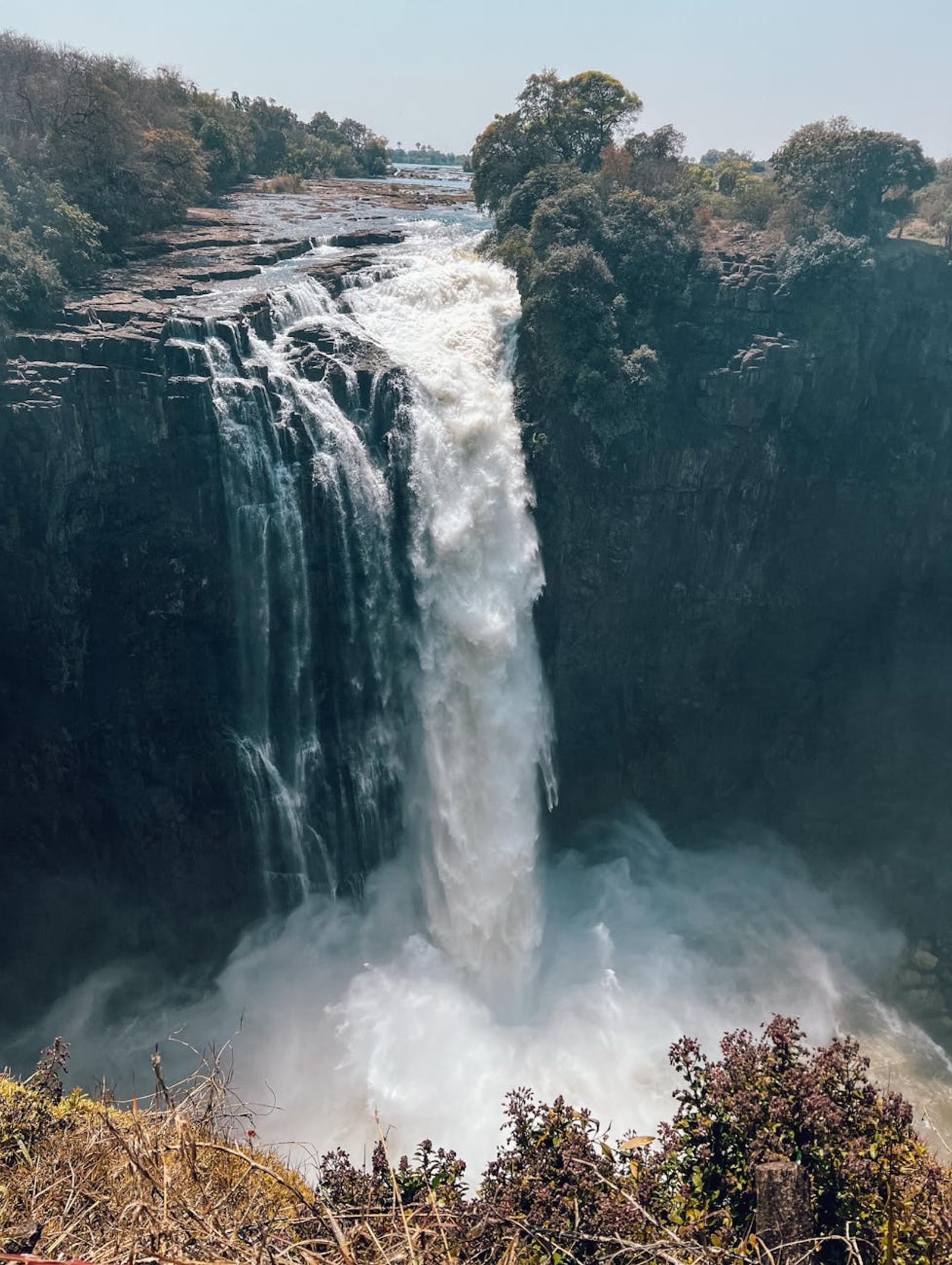Stunning view of Victoria Falls, a powerful waterfall surrounded by lush greenery