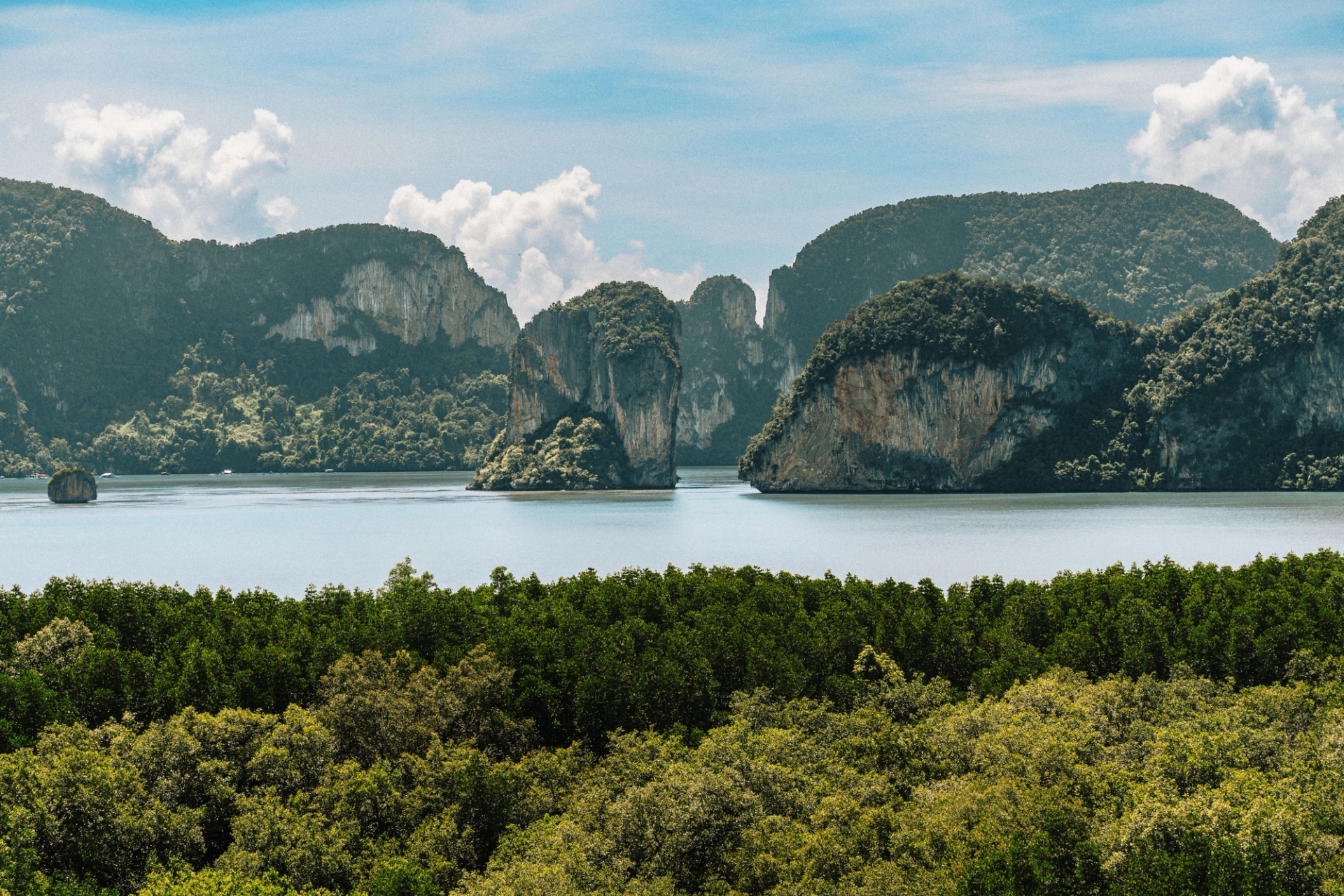 Breathtaking view of limestone cliffs in Phang Nga Bay, Krabi, Thailand, under a clear blue sky