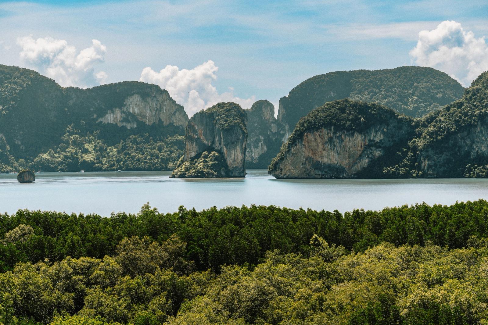 Breathtaking view of limestone cliffs in Phang Nga Bay, Krabi, Thailand, under a clear blue sky
