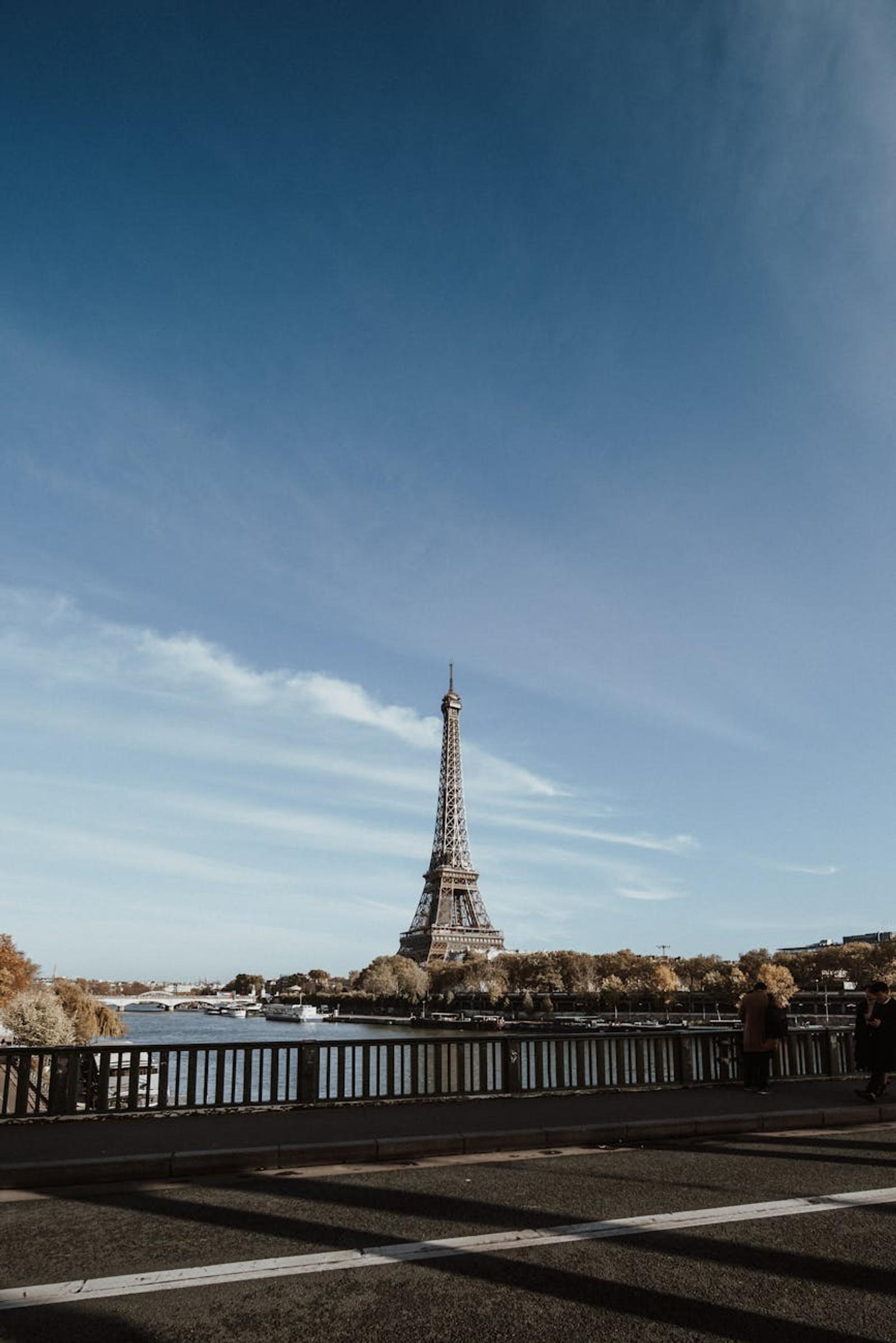 Stunning view of the Eiffel Tower from a bridge in Paris during autumn with clear blue sky