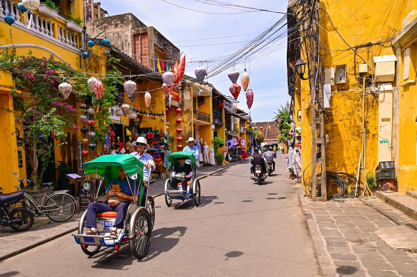 Vibrant street in Hoi An with rickshaws and lanterns