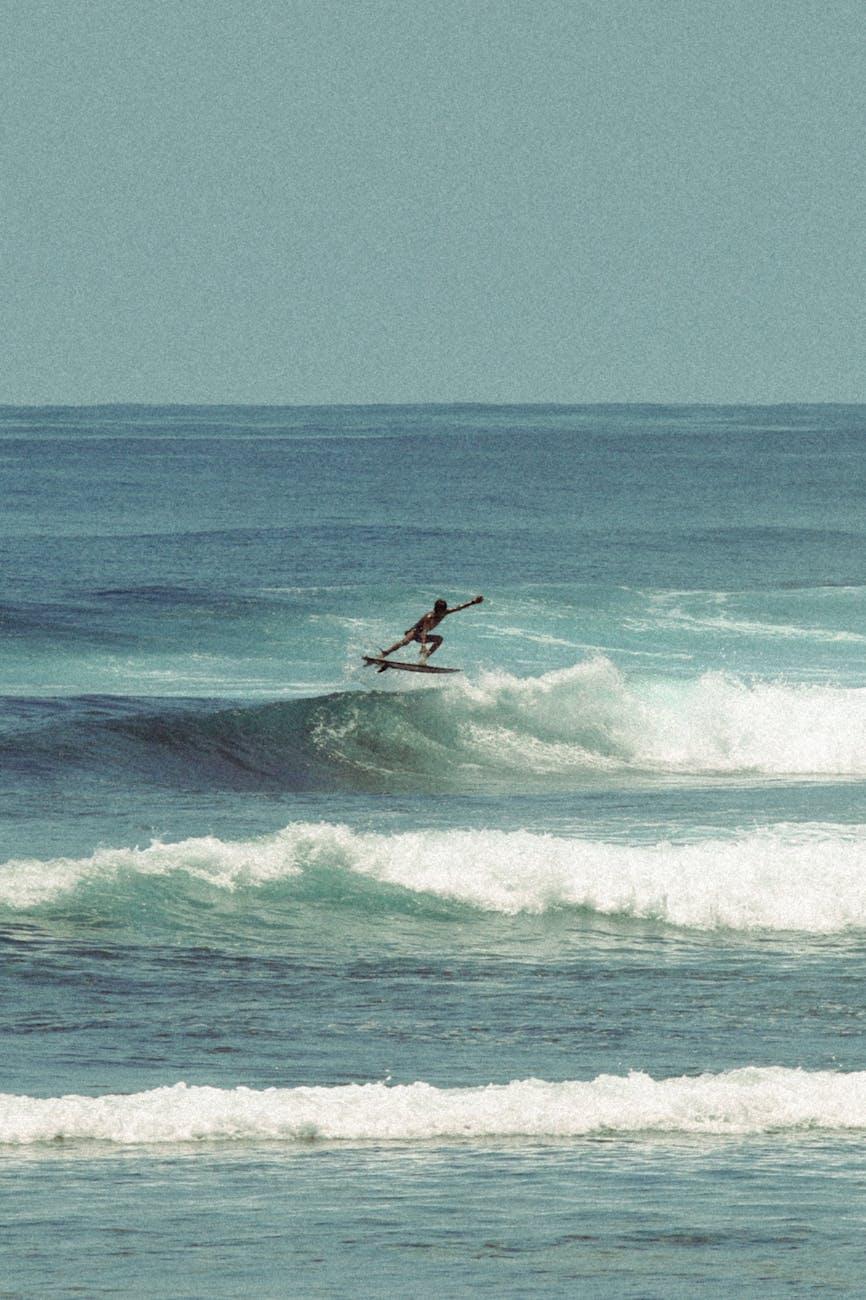 Dynamic scene of a surfer in mid-air over a wave in Bali, Indonesia