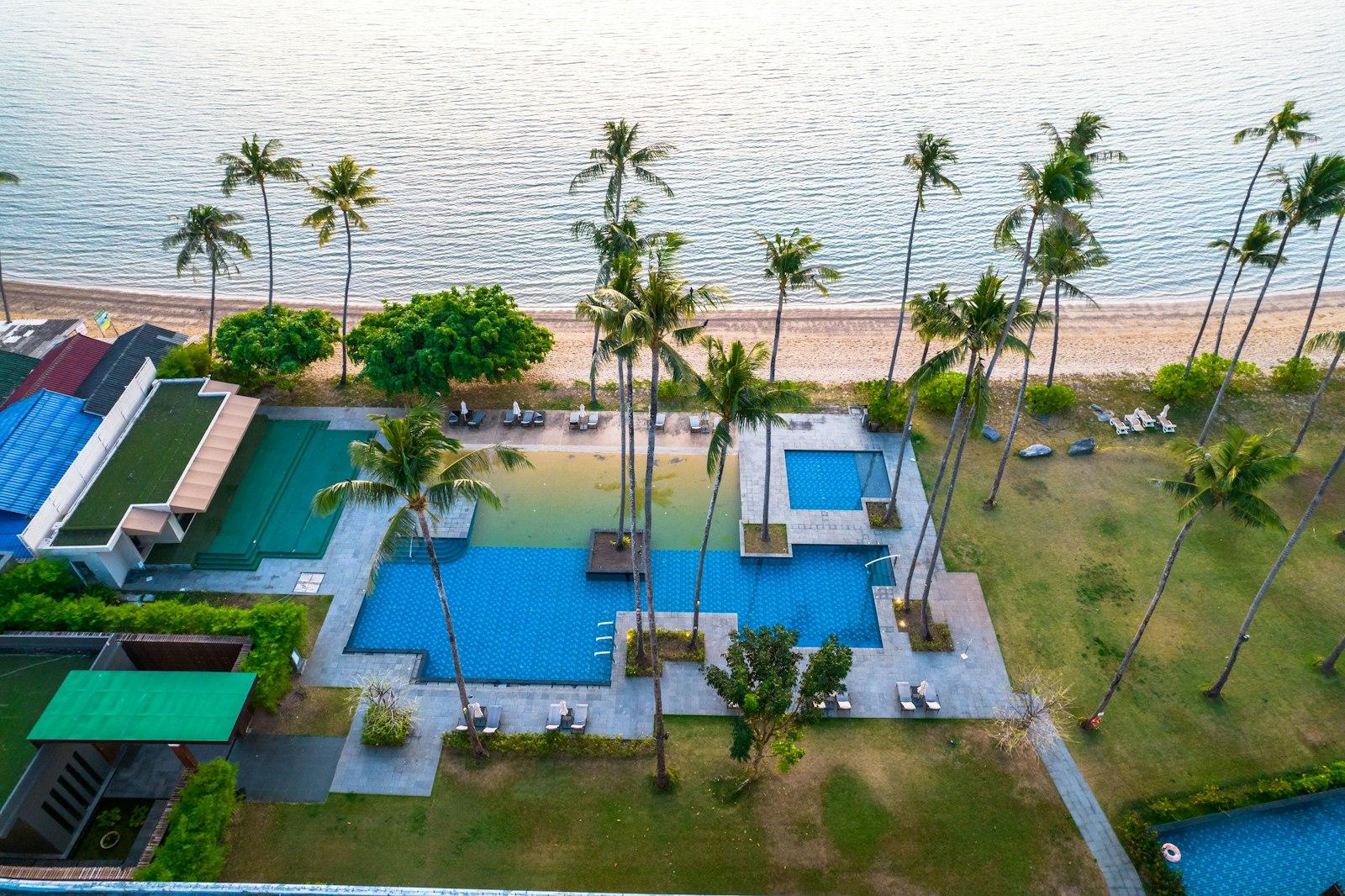 Beachfront resort pools and palms above the shoreline