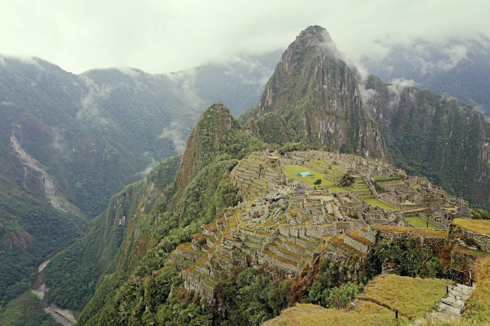 Machu Picchu's stone terraces beneath a mist-wrapped peak