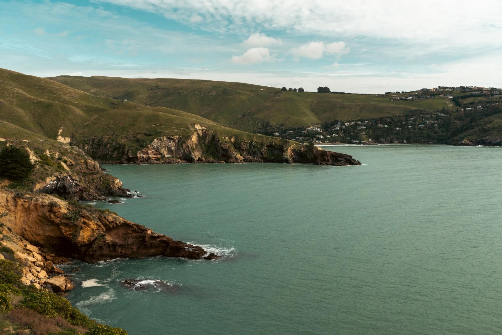 Explore the stunning coastal cliffs and tranquil waters of Lyttelton Harbour, Christchurch, New Zealand