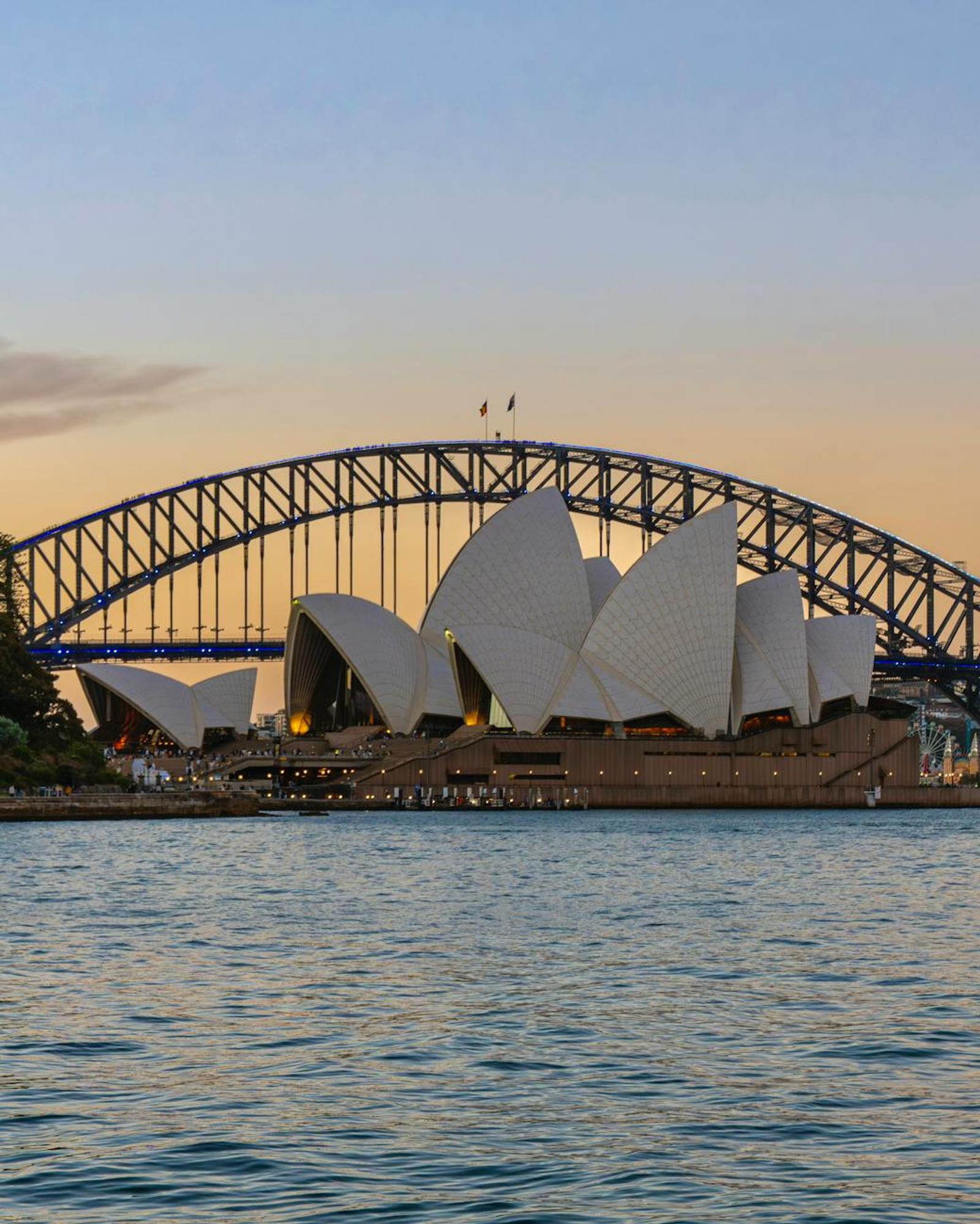 Iconic view of Sydney Opera House and Harbour Bridge during sunset