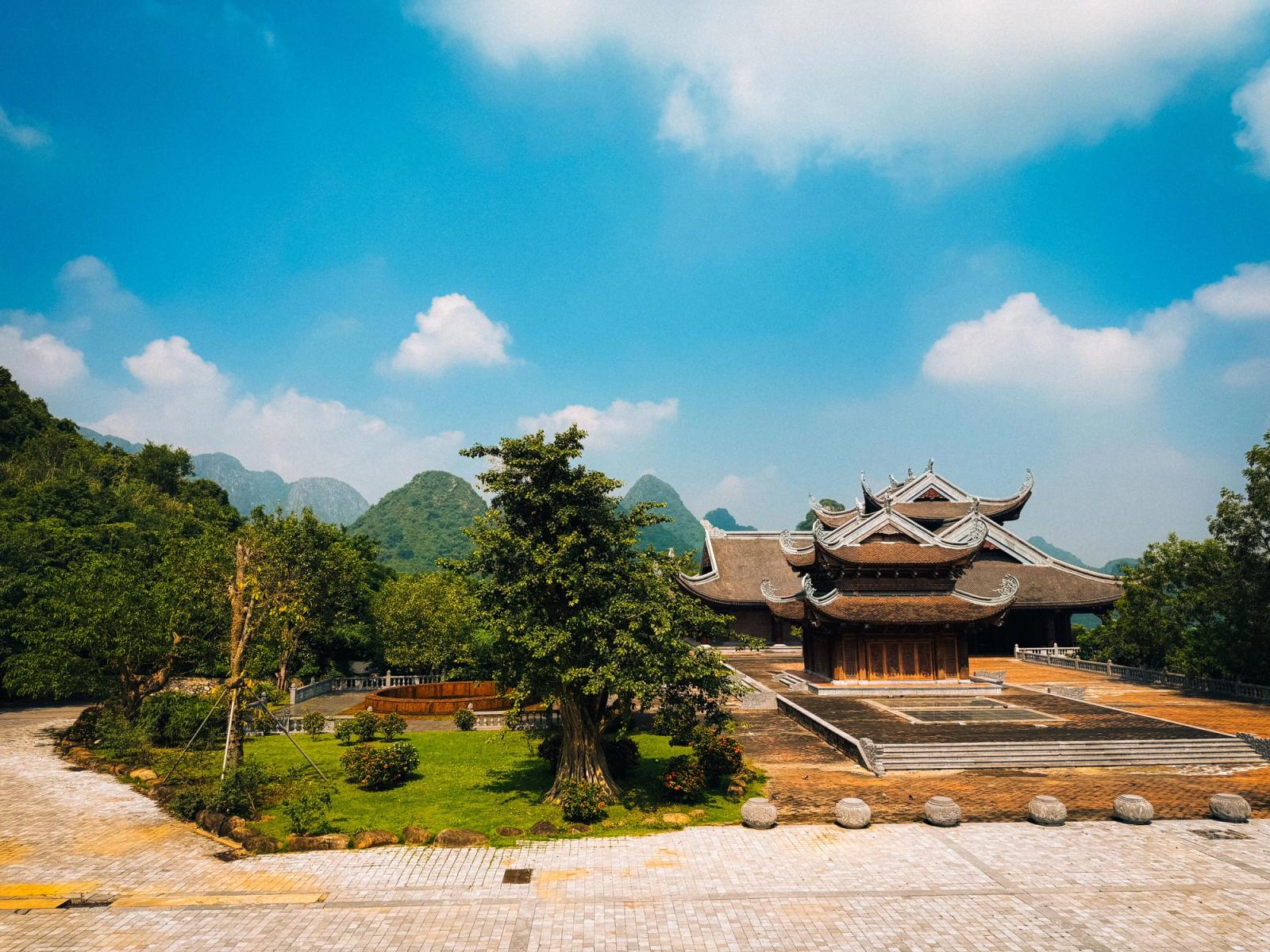 Scenic view of traditional Vietnamese temple with lush green garden in Tam Chúc, Vietnam