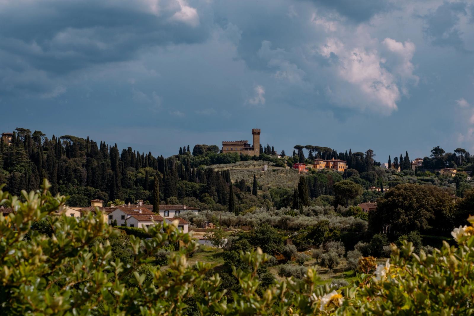 Explore the picturesque landscape of the Tuscan countryside with a historic castle near Florence