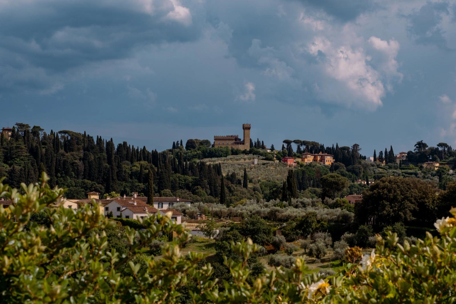 Explore the picturesque landscape of the Tuscan countryside with a historic castle near Florence