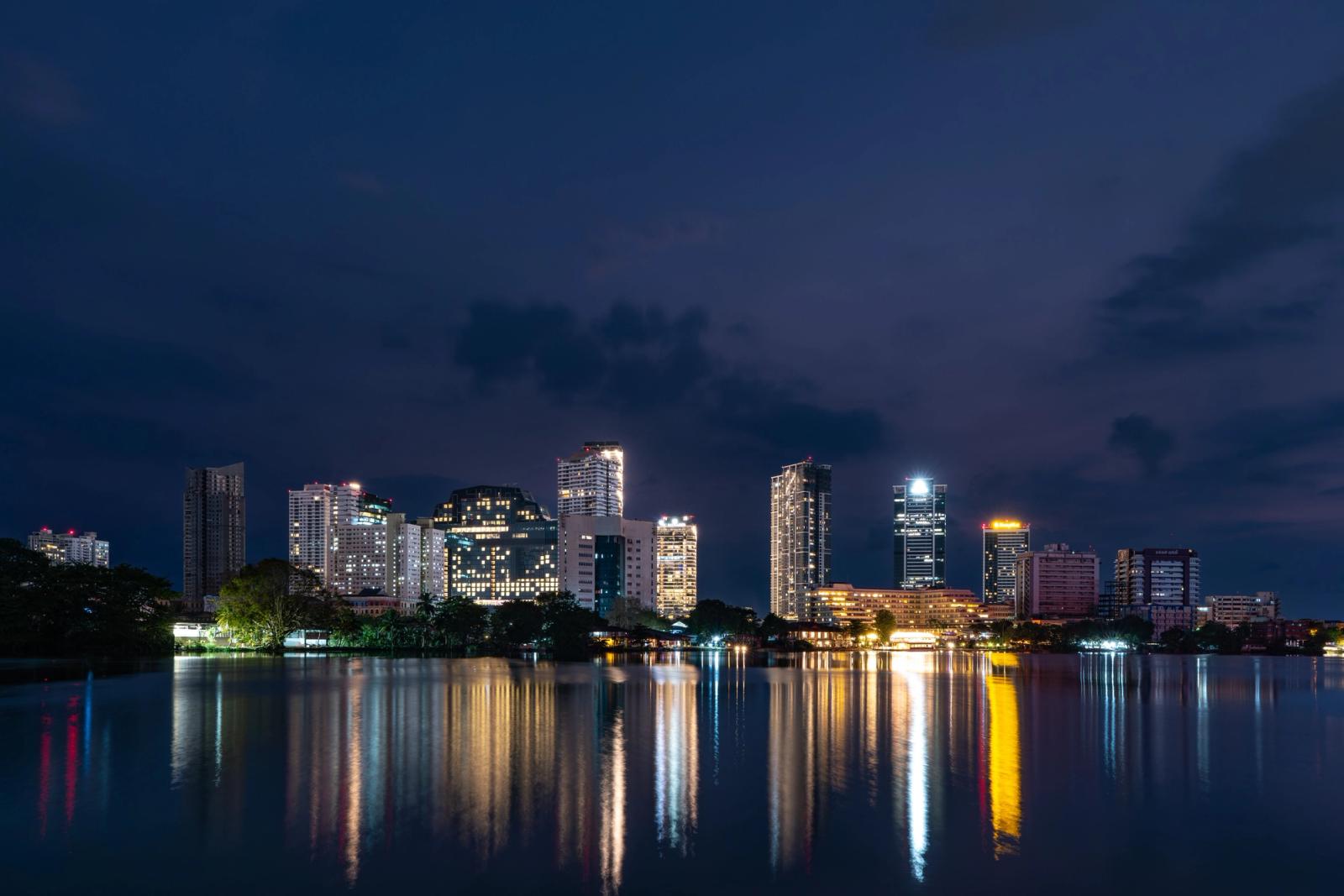 Beautiful night view of Colombo city skyline reflecting on Beira Lake in Sri Lanka