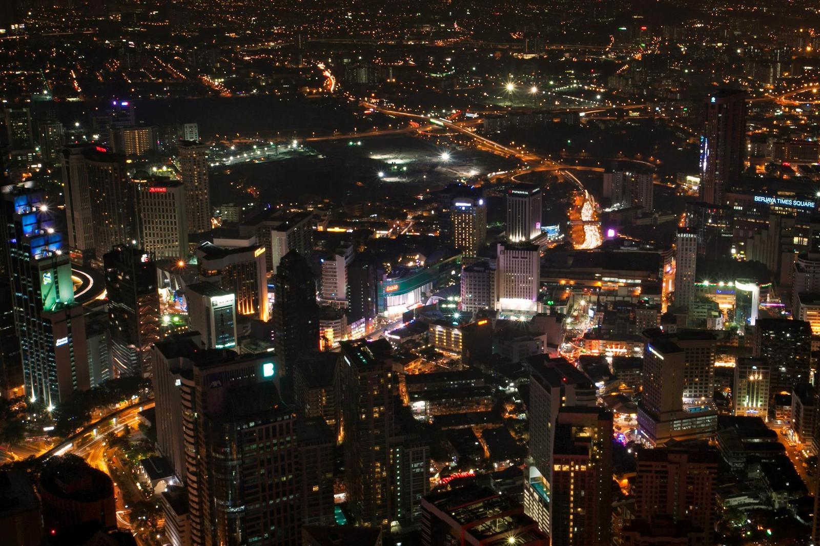 A lit-up city skyline seen from above at night