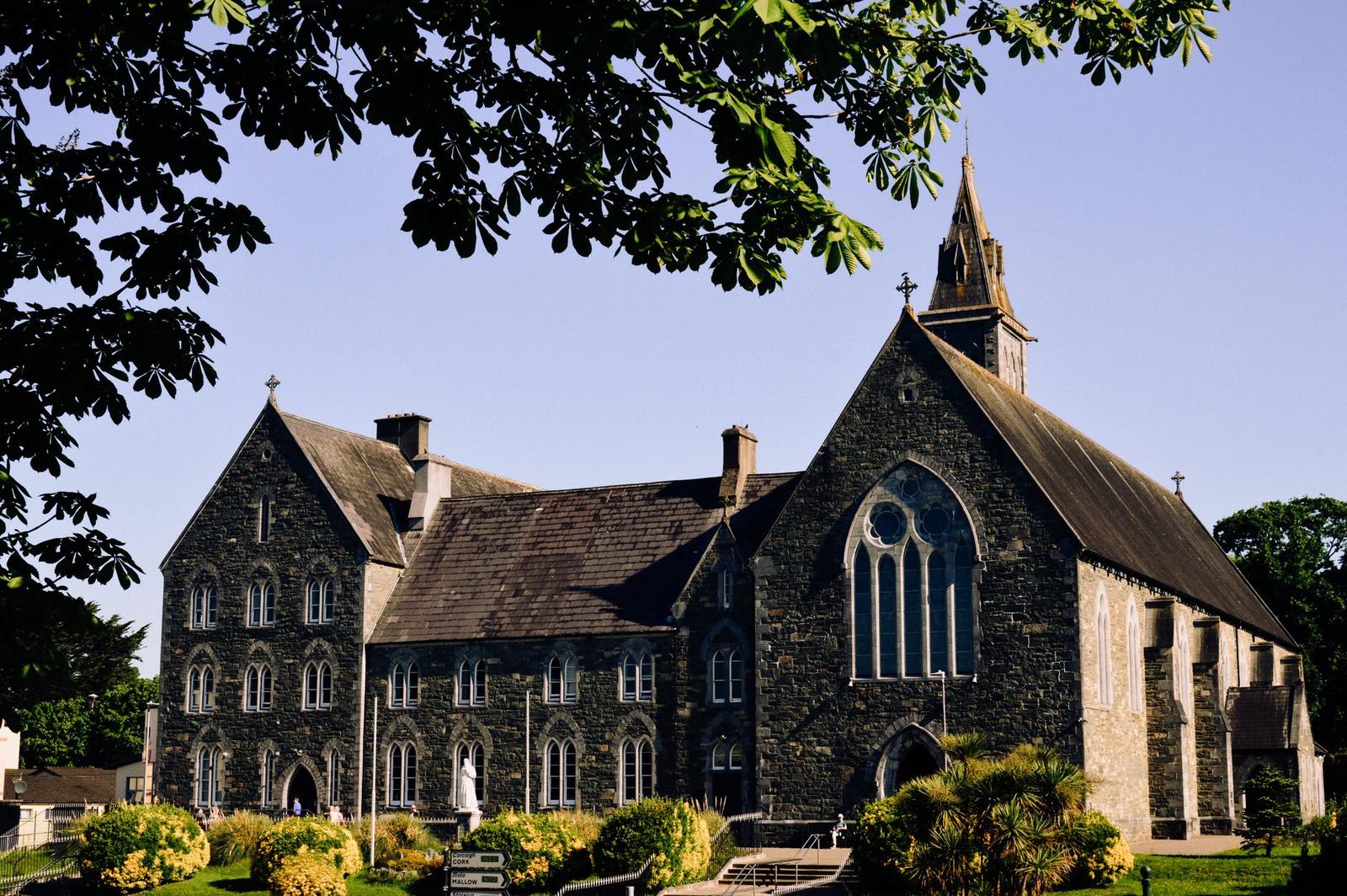 Beautiful stone church in Killarney, Ireland, under clear blue skies