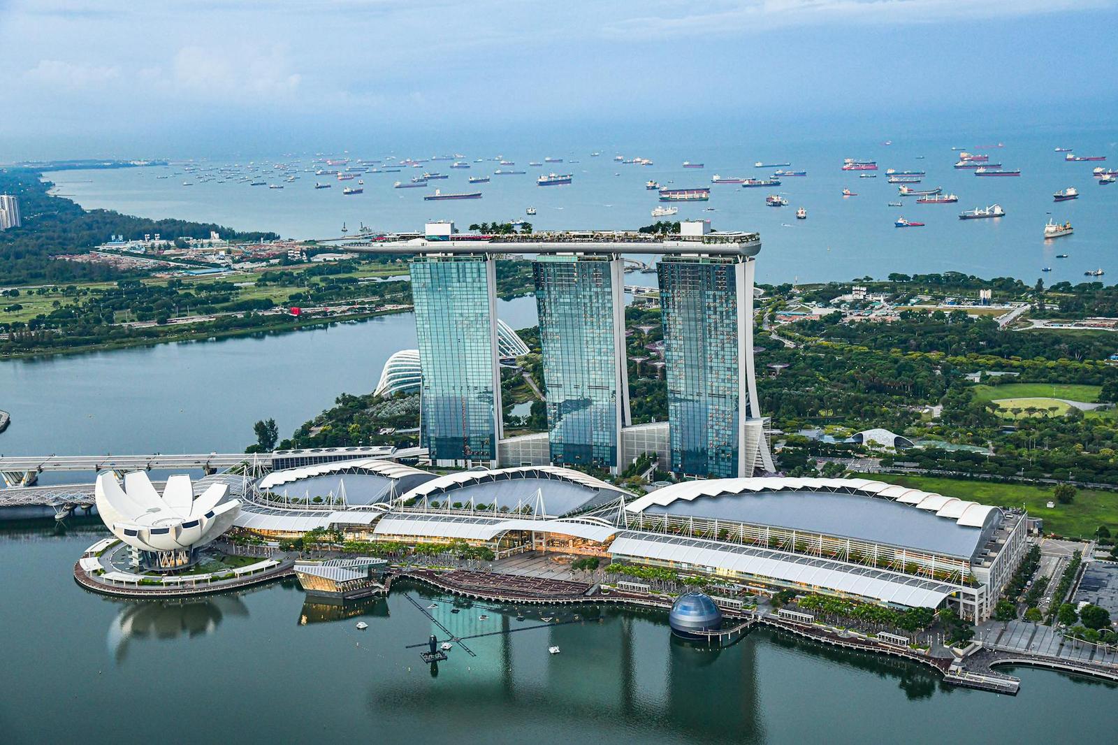 Aerial view of Marina Bay Sands and a harbour dotted with ships