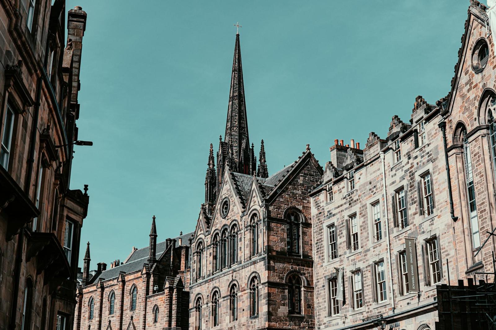 Gothic architecture in Edinburgh featuring tall spires and historic facades under a clear sky