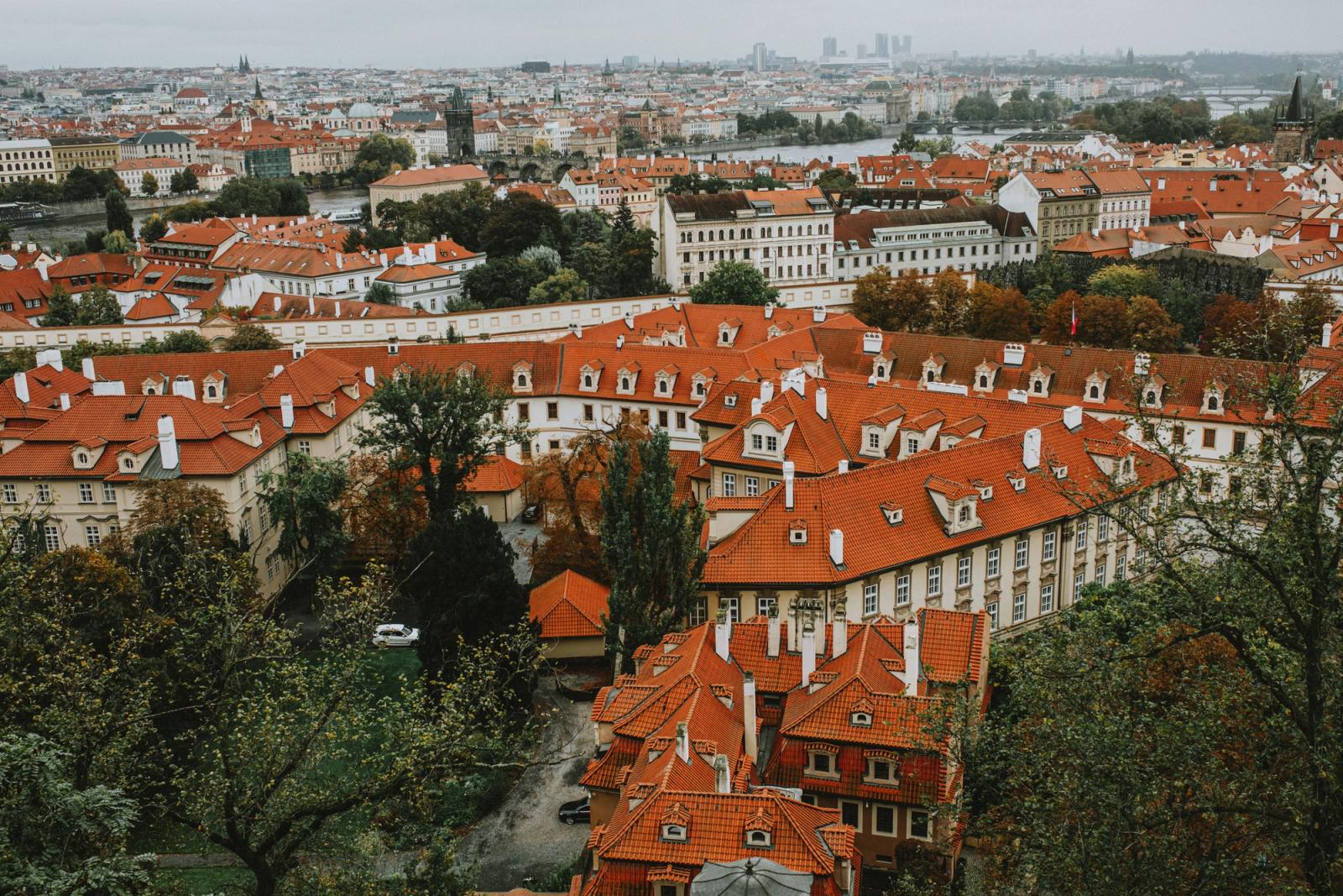 A stunning aerial view of Prague showcasing iconic red roofs and historical architecture