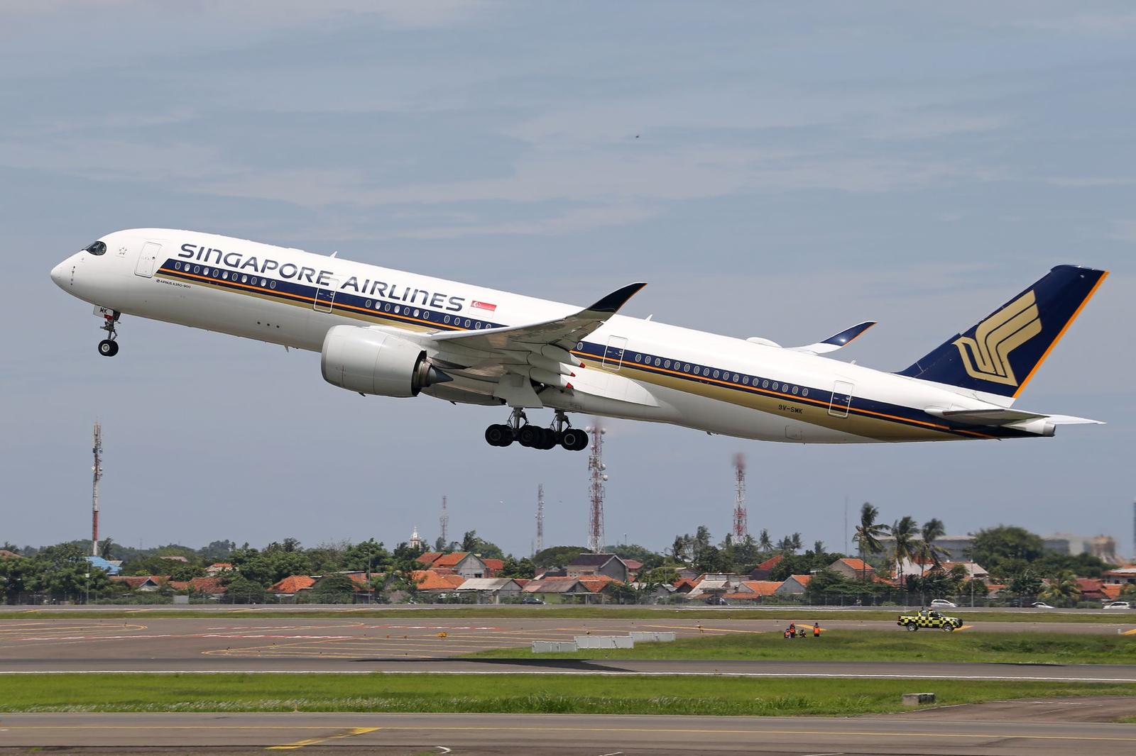 A Singapore Airlines jet climbing into the sky just after takeoff