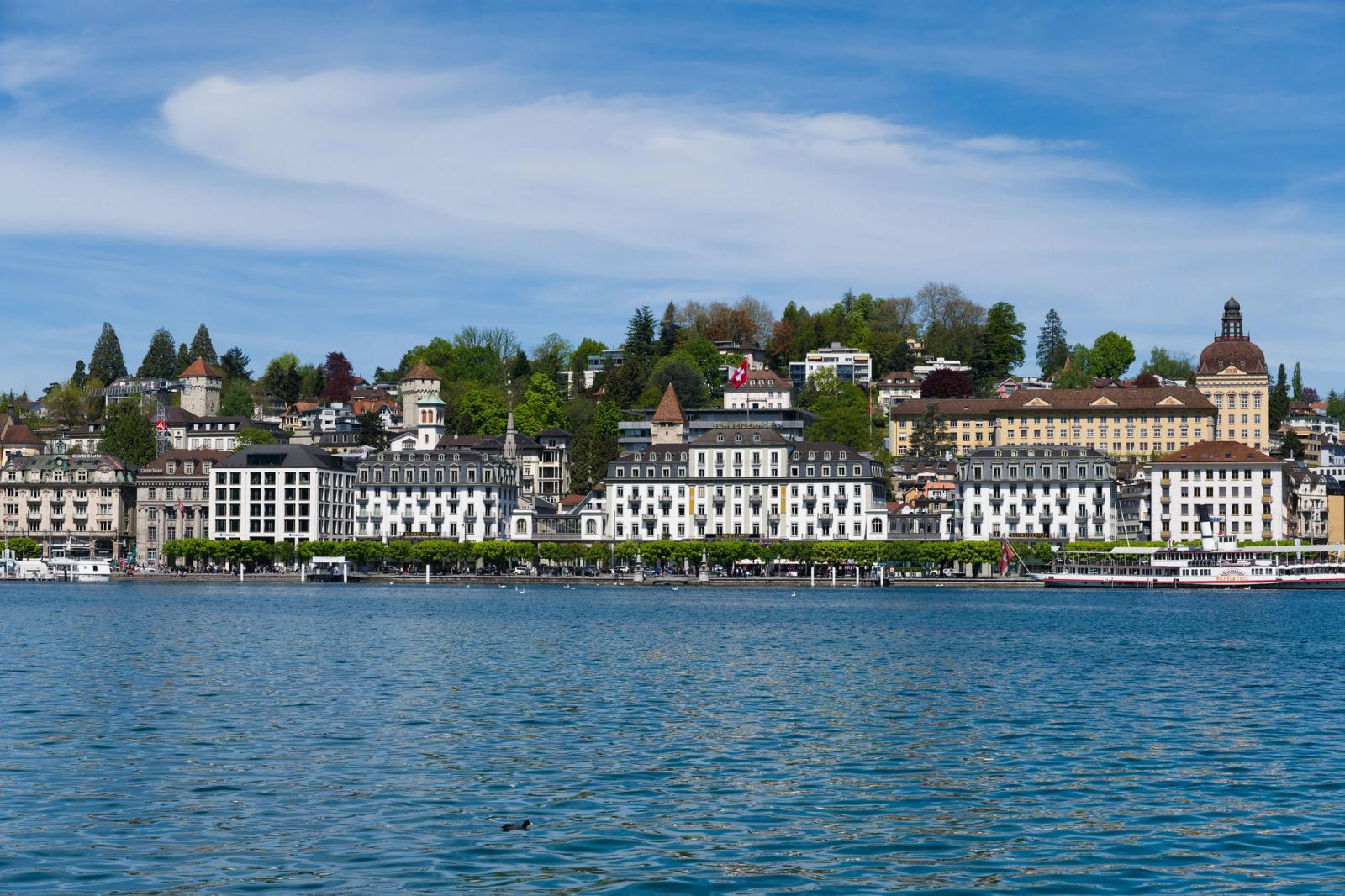 Beautiful view of Lucerne's lakeside architecture and scenic landscape under a blue sky