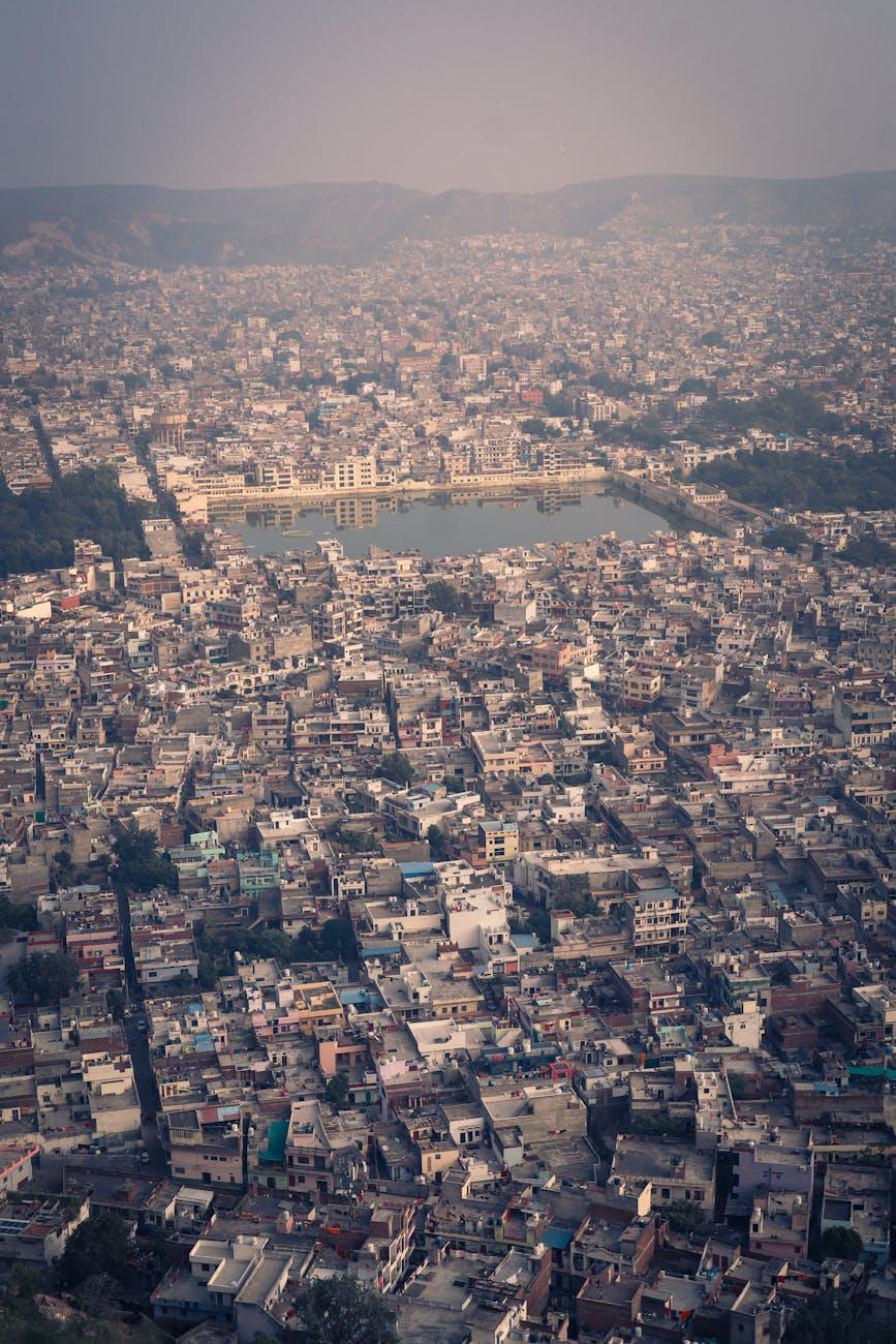 Stunning aerial view of Jaipur cityscape featuring dense urban architecture and a central lake